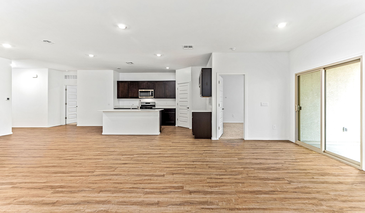 Step into The Dalea at Barnett Village, Marana, Arizona – a perfect blend of comfort, modern living, and energy efficiency. This thoughtfully crafted one-story home spans 2,224 square feet and offers five bedrooms and 3 bathrooms, ideal for families of all sizes.  The open-concept design features a spacious great room that effortlessly connects with the kitchen and dining area, creating an inviting central hub for everyday living and entertaining. The kitchen is equipped with contemporary appliances and a pantry, offering ample storage and convenience for meal preparation.  The primary bedroom, located at the rear of the home, provides a peaceful retreat with a private ensuite bathroom and a generous walk-in closet. The additional four bedrooms are positioned at the front of the house, offering versatility for use as guest rooms, a home office, or children’s bedrooms.  The Dalea floor plan offers the option of a three-car tandem garage, perfect for additional space and larger sized vehicles. Whether it’s morning coffee or evening relaxation, this outdoor space extends your living area into the serene landscape of Barnett Village.  Built with energy efficiency as a priority, the Dalea includes smart home technology, which not only simplifies daily living but also helps reduce utility costs.