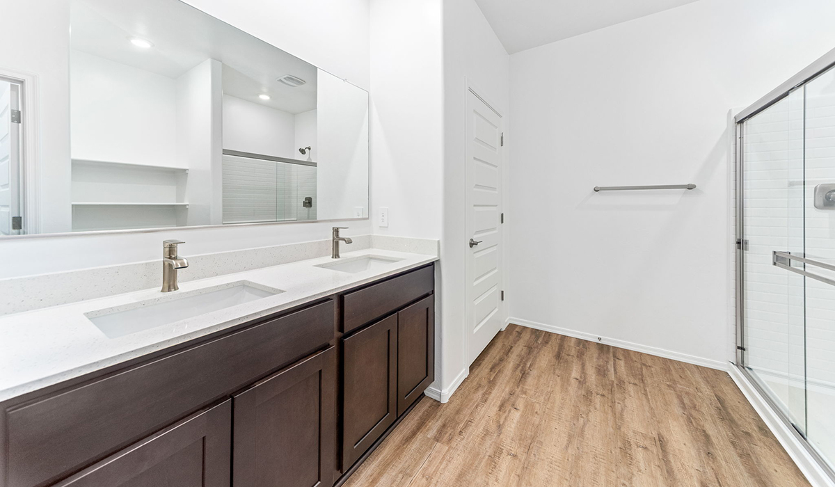 Step into The Dalea at Barnett Village, Marana, Arizona – a perfect blend of comfort, modern living, and energy efficiency. This thoughtfully crafted one-story home spans 2,224 square feet and offers five bedrooms and 3 bathrooms, ideal for families of all sizes.  The open-concept design features a spacious great room that effortlessly connects with the kitchen and dining area, creating an inviting central hub for everyday living and entertaining. The kitchen is equipped with contemporary appliances and a pantry, offering ample storage and convenience for meal preparation.  The primary bedroom, located at the rear of the home, provides a peaceful retreat with a private ensuite bathroom and a generous walk-in closet. The additional four bedrooms are positioned at the front of the house, offering versatility for use as guest rooms, a home office, or children’s bedrooms.  The Dalea floor plan offers the option of a three-car tandem garage, perfect for additional space and larger sized vehicles. Whether it’s morning coffee or evening relaxation, this outdoor space extends your living area into the serene landscape of Barnett Village.  Built with energy efficiency as a priority, the Dalea includes smart home technology, which not only simplifies daily living but also helps reduce utility costs.