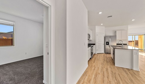 Step into The Dalea at Barnett Village, Marana, Arizona – a perfect blend of comfort, modern living, and energy efficiency. This thoughtfully crafted one-story home spans 2,224 square feet and offers five bedrooms and 3 bathrooms, ideal for families of all sizes.  The open-concept design features a spacious great room that effortlessly connects with the kitchen and dining area, creating an inviting central hub for everyday living and entertaining. The kitchen is equipped with contemporary appliances and a pantry, offering ample storage and convenience for meal preparation.  The primary bedroom, located at the rear of the home, provides a peaceful retreat with a private ensuite bathroom and a generous walk-in closet. The additional four bedrooms are positioned at the front of the house, offering versatility for use as guest rooms, a home office, or children’s bedrooms.  The Dalea floor plan offers the option of a three-car tandem garage, perfect for additional space and larger sized vehicles. Whether it’s morning coffee or evening relaxation, this outdoor space extends your living area into the serene landscape of Barnett Village.  Built with energy efficiency as a priority, the Dalea includes smart home technology, which not only simplifies daily living but also helps reduce utility costs.