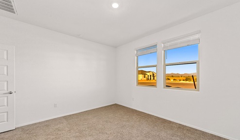 Step into The Dalea at Barnett Village, Marana, Arizona – a perfect blend of comfort, modern living, and energy efficiency. This thoughtfully crafted one-story home spans 2,224 square feet and offers five bedrooms and 3 bathrooms, ideal for families of all sizes.  The open-concept design features a spacious great room that effortlessly connects with the kitchen and dining area, creating an inviting central hub for everyday living and entertaining. The kitchen is equipped with contemporary appliances and a pantry, offering ample storage and convenience for meal preparation.  The primary bedroom, located at the rear of the home, provides a peaceful retreat with a private ensuite bathroom and a generous walk-in closet. The additional four bedrooms are positioned at the front of the house, offering versatility for use as guest rooms, a home office, or children’s bedrooms.  The Dalea floor plan offers the option of a three-car tandem garage, perfect for additional space and larger sized vehicles. Whether it’s morning coffee or evening relaxation, this outdoor space extends your living area into the serene landscape of Barnett Village.  Built with energy efficiency as a priority, the Dalea includes smart home technology, which not only simplifies daily living but also helps reduce utility costs.