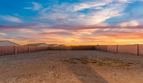 Step into The Dalea at Barnett Village, Marana, Arizona – a perfect blend of comfort, modern living, and energy efficiency. This thoughtfully crafted one-story home spans 2,224 square feet and offers five bedrooms and 3 bathrooms, ideal for families of all sizes.  The open-concept design features a spacious great room that effortlessly connects with the kitchen and dining area, creating an inviting central hub for everyday living and entertaining. The kitchen is equipped with contemporary appliances and a pantry, offering ample storage and convenience for meal preparation.  The primary bedroom, located at the rear of the home, provides a peaceful retreat with a private ensuite bathroom and a generous walk-in closet. The additional four bedrooms are positioned at the front of the house, offering versatility for use as guest rooms, a home office, or children’s bedrooms.  The Dalea floor plan offers the option of a three-car tandem garage, perfect for additional space and larger sized vehicles. Whether it’s morning coffee or evening relaxation, this outdoor space extends your living area into the serene landscape of Barnett Village.  Built with energy efficiency as a priority, the Dalea includes smart home technology, which not only simplifies daily living but also helps reduce utility costs.