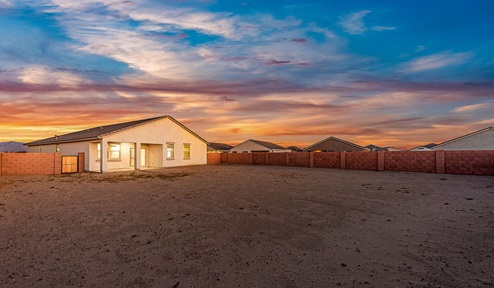 Step into The Dalea at Barnett Village, Marana, Arizona – a perfect blend of comfort, modern living, and energy efficiency. This thoughtfully crafted one-story home spans 2,224 square feet and offers five bedrooms and 3 bathrooms, ideal for families of all sizes.  The open-concept design features a spacious great room that effortlessly connects with the kitchen and dining area, creating an inviting central hub for everyday living and entertaining. The kitchen is equipped with contemporary appliances and a pantry, offering ample storage and convenience for meal preparation.  The primary bedroom, located at the rear of the home, provides a peaceful retreat with a private ensuite bathroom and a generous walk-in closet. The additional four bedrooms are positioned at the front of the house, offering versatility for use as guest rooms, a home office, or children’s bedrooms.  The Dalea floor plan offers the option of a three-car tandem garage, perfect for additional space and larger sized vehicles. Whether it’s morning coffee or evening relaxation, this outdoor space extends your living area into the serene landscape of Barnett Village.  Built with energy efficiency as a priority, the Dalea includes smart home technology, which not only simplifies daily living but also helps reduce utility costs.