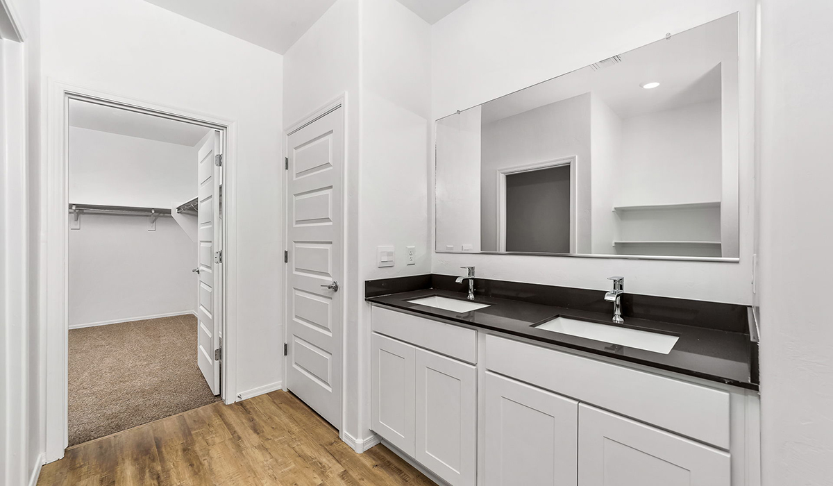 Step into The Dalea at Barnett Village, Marana, Arizona – a perfect blend of comfort, modern living, and energy efficiency. This thoughtfully crafted one-story home spans 2,224 square feet and offers five bedrooms and 3 bathrooms, ideal for families of all sizes.  The open-concept design features a spacious great room that effortlessly connects with the kitchen and dining area, creating an inviting central hub for everyday living and entertaining. The kitchen is equipped with contemporary appliances and a pantry, offering ample storage and convenience for meal preparation.  The primary bedroom, located at the rear of the home, provides a peaceful retreat with a private ensuite bathroom and a generous walk-in closet. The additional four bedrooms are positioned at the front of the house, offering versatility for use as guest rooms, a home office, or children’s bedrooms.  The Dalea floor plan offers the option of a three-car tandem garage, perfect for additional space and larger sized vehicles. Whether it’s morning coffee or evening relaxation, this outdoor space extends your living area into the serene landscape of Barnett Village.  Built with energy efficiency as a priority, the Dalea includes smart home technology, which not only simplifies daily living but also helps reduce utility costs.