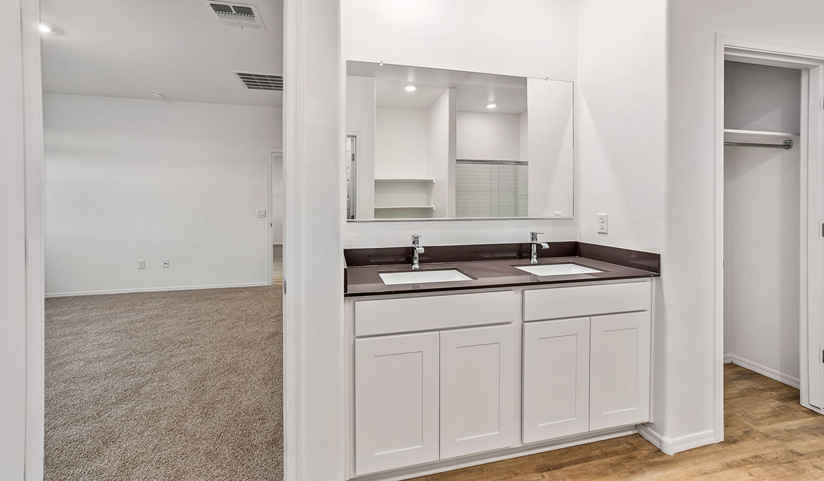 Step into The Dalea at Barnett Village, Marana, Arizona – a perfect blend of comfort, modern living, and energy efficiency. This thoughtfully crafted one-story home spans 2,224 square feet and offers five bedrooms and 3 bathrooms, ideal for families of all sizes.  The open-concept design features a spacious great room that effortlessly connects with the kitchen and dining area, creating an inviting central hub for everyday living and entertaining. The kitchen is equipped with contemporary appliances and a pantry, offering ample storage and convenience for meal preparation.  The primary bedroom, located at the rear of the home, provides a peaceful retreat with a private ensuite bathroom and a generous walk-in closet. The additional four bedrooms are positioned at the front of the house, offering versatility for use as guest rooms, a home office, or children’s bedrooms.  The Dalea floor plan offers the option of a three-car tandem garage, perfect for additional space and larger sized vehicles. Whether it’s morning coffee or evening relaxation, this outdoor space extends your living area into the serene landscape of Barnett Village.  Built with energy efficiency as a priority, the Dalea includes smart home technology, which not only simplifies daily living but also helps reduce utility costs.