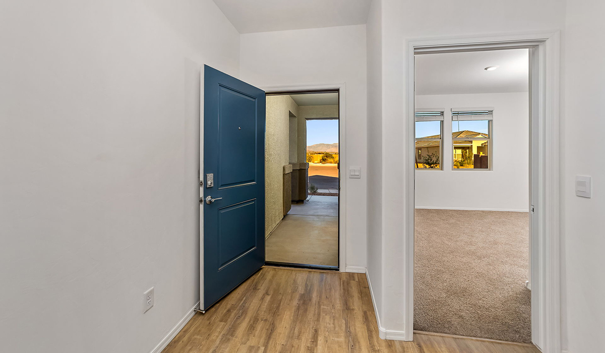 Step into The Dalea at Barnett Village, Marana, Arizona – a perfect blend of comfort, modern living, and energy efficiency. This thoughtfully crafted one-story home spans 2,224 square feet and offers five bedrooms and 3 bathrooms, ideal for families of all sizes.  The open-concept design features a spacious great room that effortlessly connects with the kitchen and dining area, creating an inviting central hub for everyday living and entertaining. The kitchen is equipped with contemporary appliances and a pantry, offering ample storage and convenience for meal preparation.  The primary bedroom, located at the rear of the home, provides a peaceful retreat with a private ensuite bathroom and a generous walk-in closet. The additional four bedrooms are positioned at the front of the house, offering versatility for use as guest rooms, a home office, or children’s bedrooms.  The Dalea floor plan offers the option of a three-car tandem garage, perfect for additional space and larger sized vehicles. Whether it’s morning coffee or evening relaxation, this outdoor space extends your living area into the serene landscape of Barnett Village.  Built with energy efficiency as a priority, the Dalea includes smart home technology, which not only simplifies daily living but also helps reduce utility costs.