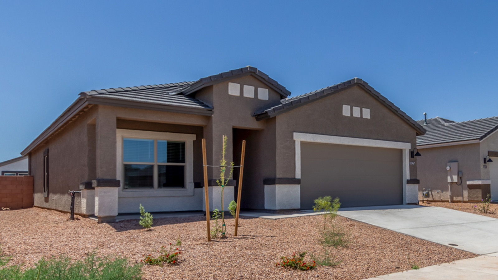 Step into The Baxter at Barnett Village, Marana, Arizona – a beautifully designed 1,423 sq. ft. single-story new home that seamlessly blends modern comfort with thoughtful functionality.  As you enter through the welcoming front porch, you're greeted by an inviting entryway that leads directly into the heart of the home – a spacious and open-concept great room. This area flows effortlessly into the dining space, creating an ideal setting for family gatherings and entertaining guests.  The gourmet kitchen, adjacent to the dining room, features elegant granite countertops, a large island with a breakfast bar, and a walk-in pantry. It’s a space where culinary creativity meets convenience, complete with modern appliances and plenty of storage.  Tucked away in the rear of the home is the master suite, offering privacy and comfort. The suite includes a generous walk-in closet and a luxurious en-suite bathroom with dual vanities and a walk-in shower. Large windows let in plenty of natural light, creating a serene retreat within the home.  Two additional bedrooms are located toward the front of the house, each with easy access to a full bathroom. These rooms are perfect for family, guests, or even a home office.  The Baxter also boasts a covered patio, perfect for enjoying Arizona’s beautiful desert evenings. Whether it’s morning coffee or evening relaxation, this outdoor space extends your living area into the serene landscape of Barnett Village.  With a two-car garage and energy-efficient features that include DOE Zero Energy Ready Home certification, The Baxter at Barnett Village offers not just a home, but a lifestyle that emphasizes comfort, sustainability, and convenience.  *Images shown are for reference only. They depict The Baxter spec home and may not represent the actual home.