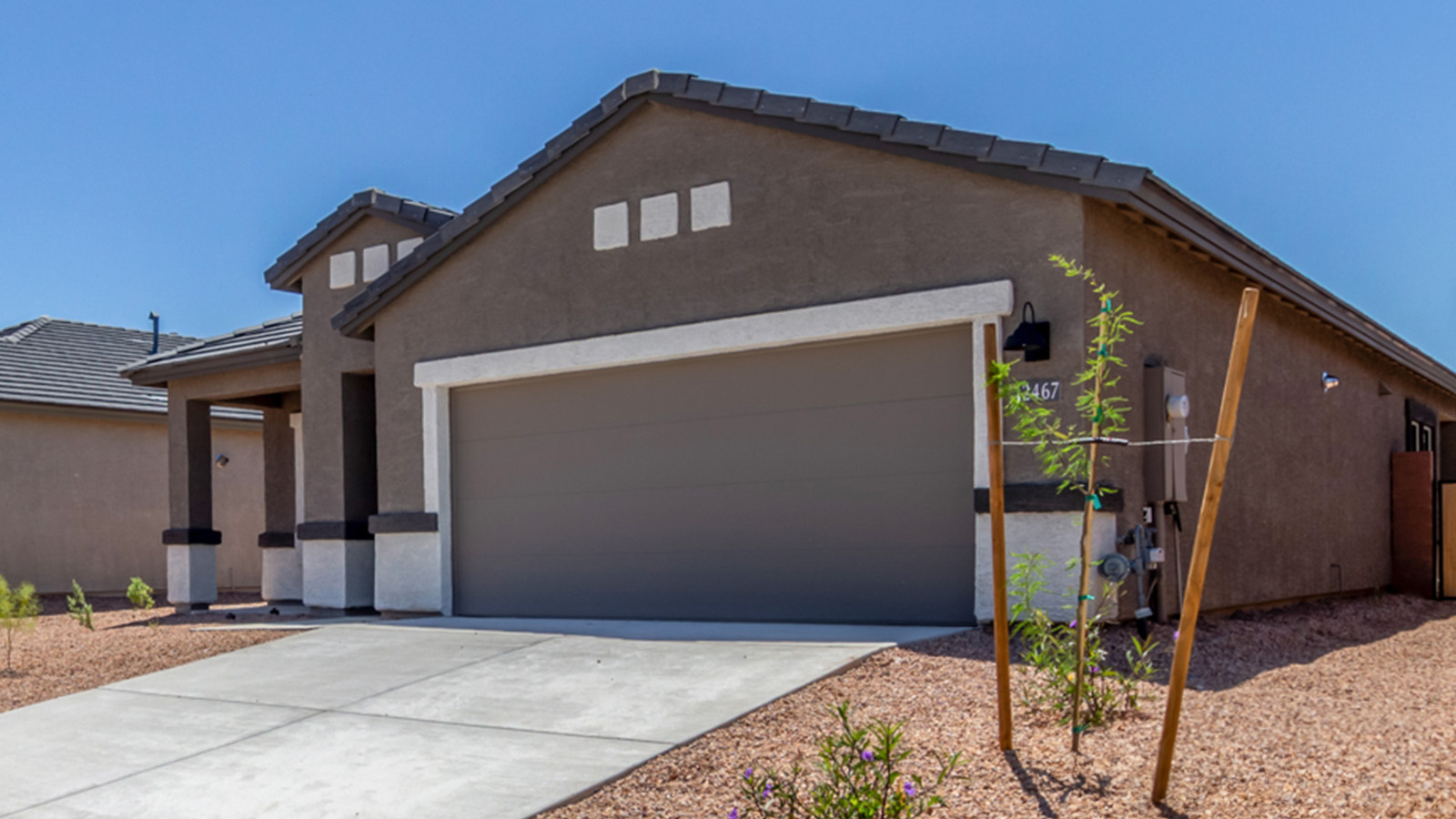 Step into The Baxter at Barnett Village, Marana, Arizona – a beautifully designed 1,423 sq. ft. single-story new home that seamlessly blends modern comfort with thoughtful functionality.  As you enter through the welcoming front porch, you're greeted by an inviting entryway that leads directly into the heart of the home – a spacious and open-concept great room. This area flows effortlessly into the dining space, creating an ideal setting for family gatherings and entertaining guests.  The gourmet kitchen, adjacent to the dining room, features elegant granite countertops, a large island with a breakfast bar, and a walk-in pantry. It’s a space where culinary creativity meets convenience, complete with modern appliances and plenty of storage.  Tucked away in the rear of the home is the master suite, offering privacy and comfort. The suite includes a generous walk-in closet and a luxurious en-suite bathroom with dual vanities and a walk-in shower. Large windows let in plenty of natural light, creating a serene retreat within the home.  Two additional bedrooms are located toward the front of the house, each with easy access to a full bathroom. These rooms are perfect for family, guests, or even a home office.  The Baxter also boasts a covered patio, perfect for enjoying Arizona’s beautiful desert evenings. Whether it’s morning coffee or evening relaxation, this outdoor space extends your living area into the serene landscape of Barnett Village.  With a two-car garage and energy-efficient features that include DOE Zero Energy Ready Home certification, The Baxter at Barnett Village offers not just a home, but a lifestyle that emphasizes comfort, sustainability, and convenience.  *Images shown are for reference only. They depict The Baxter spec home and may not represent the actual home.