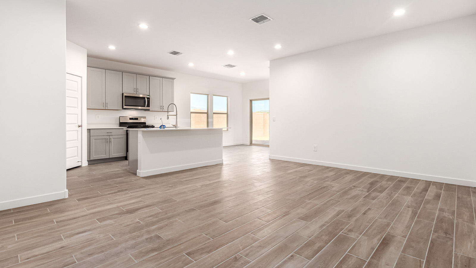 Step into The Baxter at Barnett Village, Marana, Arizona – a beautifully designed 1,423 sq. ft. single-story new home that seamlessly blends modern comfort with thoughtful functionality.  As you enter through the welcoming front porch, you're greeted by an inviting entryway that leads directly into the heart of the home – a spacious and open-concept great room. This area flows effortlessly into the dining space, creating an ideal setting for family gatherings and entertaining guests.  The gourmet kitchen, adjacent to the dining room, features elegant granite countertops, a large island with a breakfast bar, and a walk-in pantry. It’s a space where culinary creativity meets convenience, complete with modern appliances and plenty of storage.  Tucked away in the rear of the home is the master suite, offering privacy and comfort. The suite includes a generous walk-in closet and a luxurious en-suite bathroom with dual vanities and a walk-in shower. Large windows let in plenty of natural light, creating a serene retreat within the home.  Two additional bedrooms are located toward the front of the house, each with easy access to a full bathroom. These rooms are perfect for family, guests, or even a home office.  The Baxter also boasts a covered patio, perfect for enjoying Arizona’s beautiful desert evenings. Whether it’s morning coffee or evening relaxation, this outdoor space extends your living area into the serene landscape of Barnett Village.  With a two-car garage and energy-efficient features that include DOE Zero Energy Ready Home certification, The Baxter at Barnett Village offers not just a home, but a lifestyle that emphasizes comfort, sustainability, and convenience.  *Images shown are for reference only. They depict the Baxter model home and may not represent the actual home.