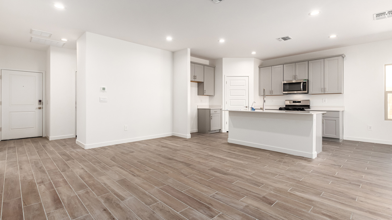 Step into The Baxter at Barnett Village, Marana, Arizona – a beautifully designed 1,423 sq. ft. single-story new home that seamlessly blends modern comfort with thoughtful functionality.  As you enter through the welcoming front porch, you're greeted by an inviting entryway that leads directly into the heart of the home – a spacious and open-concept great room. This area flows effortlessly into the dining space, creating an ideal setting for family gatherings and entertaining guests.  The gourmet kitchen, adjacent to the dining room, features elegant granite countertops, a large island with a breakfast bar, and a walk-in pantry. It’s a space where culinary creativity meets convenience, complete with modern appliances and plenty of storage.  Tucked away in the rear of the home is the master suite, offering privacy and comfort. The suite includes a generous walk-in closet and a luxurious en-suite bathroom with dual vanities and a walk-in shower. Large windows let in plenty of natural light, creating a serene retreat within the home.  Two additional bedrooms are located toward the front of the house, each with easy access to a full bathroom. These rooms are perfect for family, guests, or even a home office.  The Baxter also boasts a covered patio, perfect for enjoying Arizona’s beautiful desert evenings. Whether it’s morning coffee or evening relaxation, this outdoor space extends your living area into the serene landscape of Barnett Village.  With a two-car garage and energy-efficient features that include DOE Zero Energy Ready Home certification, The Baxter at Barnett Village offers not just a home, but a lifestyle that emphasizes comfort, sustainability, and convenience.  *Images shown are for reference only. They depict the Baxter model home and may not represent the actual home.