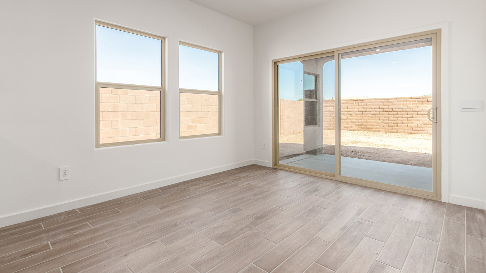 Step into The Baxter at Barnett Village, Marana, Arizona – a beautifully designed 1,423 sq. ft. single-story new home that seamlessly blends modern comfort with thoughtful functionality.  As you enter through the welcoming front porch, you're greeted by an inviting entryway that leads directly into the heart of the home – a spacious and open-concept great room. This area flows effortlessly into the dining space, creating an ideal setting for family gatherings and entertaining guests.  The gourmet kitchen, adjacent to the dining room, features elegant granite countertops, a large island with a breakfast bar, and a walk-in pantry. It’s a space where culinary creativity meets convenience, complete with modern appliances and plenty of storage.  Tucked away in the rear of the home is the master suite, offering privacy and comfort. The suite includes a generous walk-in closet and a luxurious en-suite bathroom with dual vanities and a walk-in shower. Large windows let in plenty of natural light, creating a serene retreat within the home.  Two additional bedrooms are located toward the front of the house, each with easy access to a full bathroom. These rooms are perfect for family, guests, or even a home office.  The Baxter also boasts a covered patio, perfect for enjoying Arizona’s beautiful desert evenings. Whether it’s morning coffee or evening relaxation, this outdoor space extends your living area into the serene landscape of Barnett Village.  With a two-car garage and energy-efficient features that include DOE Zero Energy Ready Home certification, The Baxter at Barnett Village offers not just a home, but a lifestyle that emphasizes comfort, sustainability, and convenience.  *Images shown are for reference only. They depict the Baxter model home and may not represent the actual home.