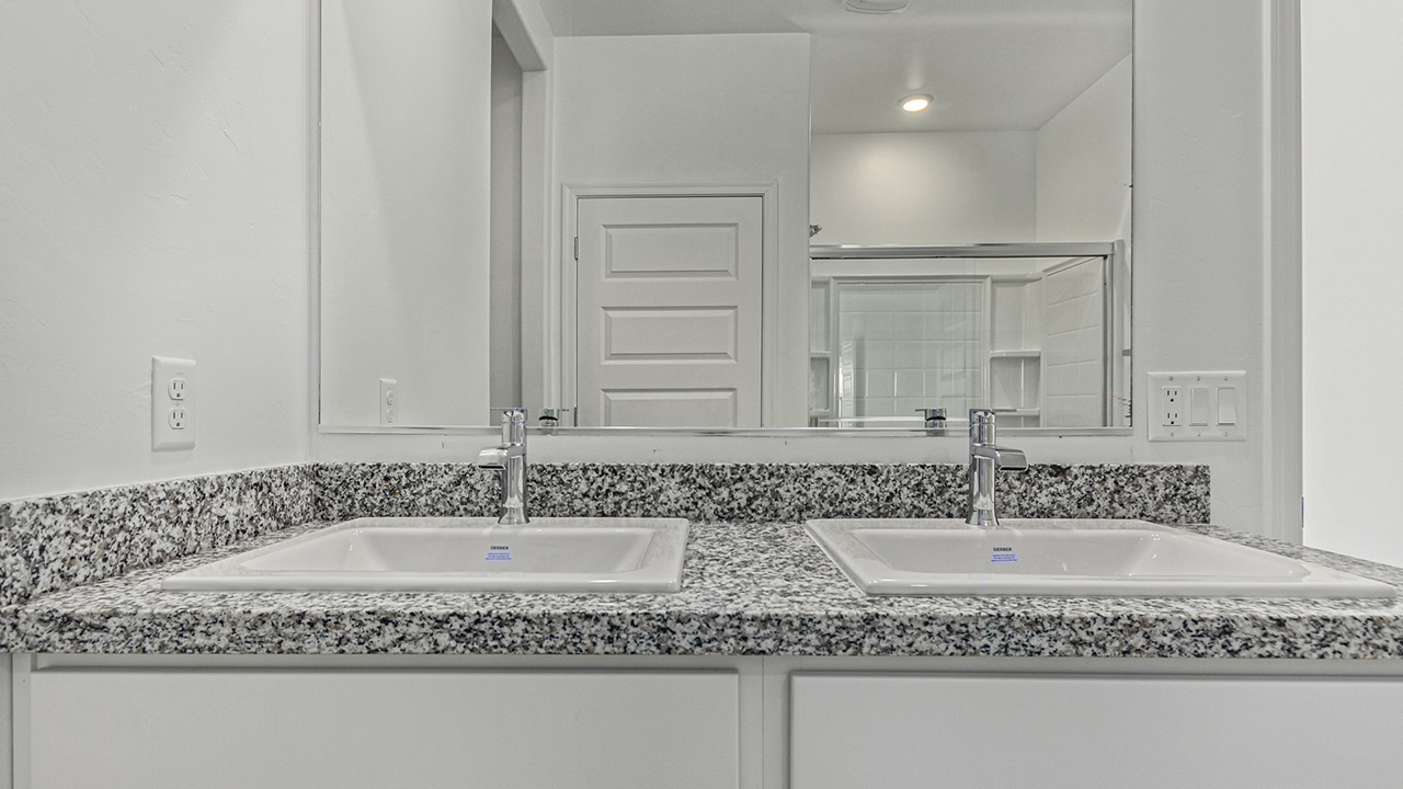 Step into The Baxter at Barnett Village, Marana, Arizona – a beautifully designed 1,423 sq. ft. single-story new home that seamlessly blends modern comfort with thoughtful functionality.  As you enter through the welcoming front porch, you're greeted by an inviting entryway that leads directly into the heart of the home – a spacious and open-concept great room. This area flows effortlessly into the dining space, creating an ideal setting for family gatherings and entertaining guests.  The gourmet kitchen, adjacent to the dining room, features elegant granite countertops, a large island with a breakfast bar, and a walk-in pantry. It’s a space where culinary creativity meets convenience, complete with modern appliances and plenty of storage.  Tucked away in the rear of the home is the master suite, offering privacy and comfort. The suite includes a generous walk-in closet and a luxurious en-suite bathroom with dual vanities and a walk-in shower. Large windows let in plenty of natural light, creating a serene retreat within the home.  Two additional bedrooms are located toward the front of the house, each with easy access to a full bathroom. These rooms are perfect for family, guests, or even a home office.  The Baxter also boasts a covered patio, perfect for enjoying Arizona’s beautiful desert evenings. Whether it’s morning coffee or evening relaxation, this outdoor space extends your living area into the serene landscape of Barnett Village.  With a two-car garage and energy-efficient features that include DOE Zero Energy Ready Home certification, The Baxter at Barnett Village offers not just a home, but a lifestyle that emphasizes comfort, sustainability, and convenience.