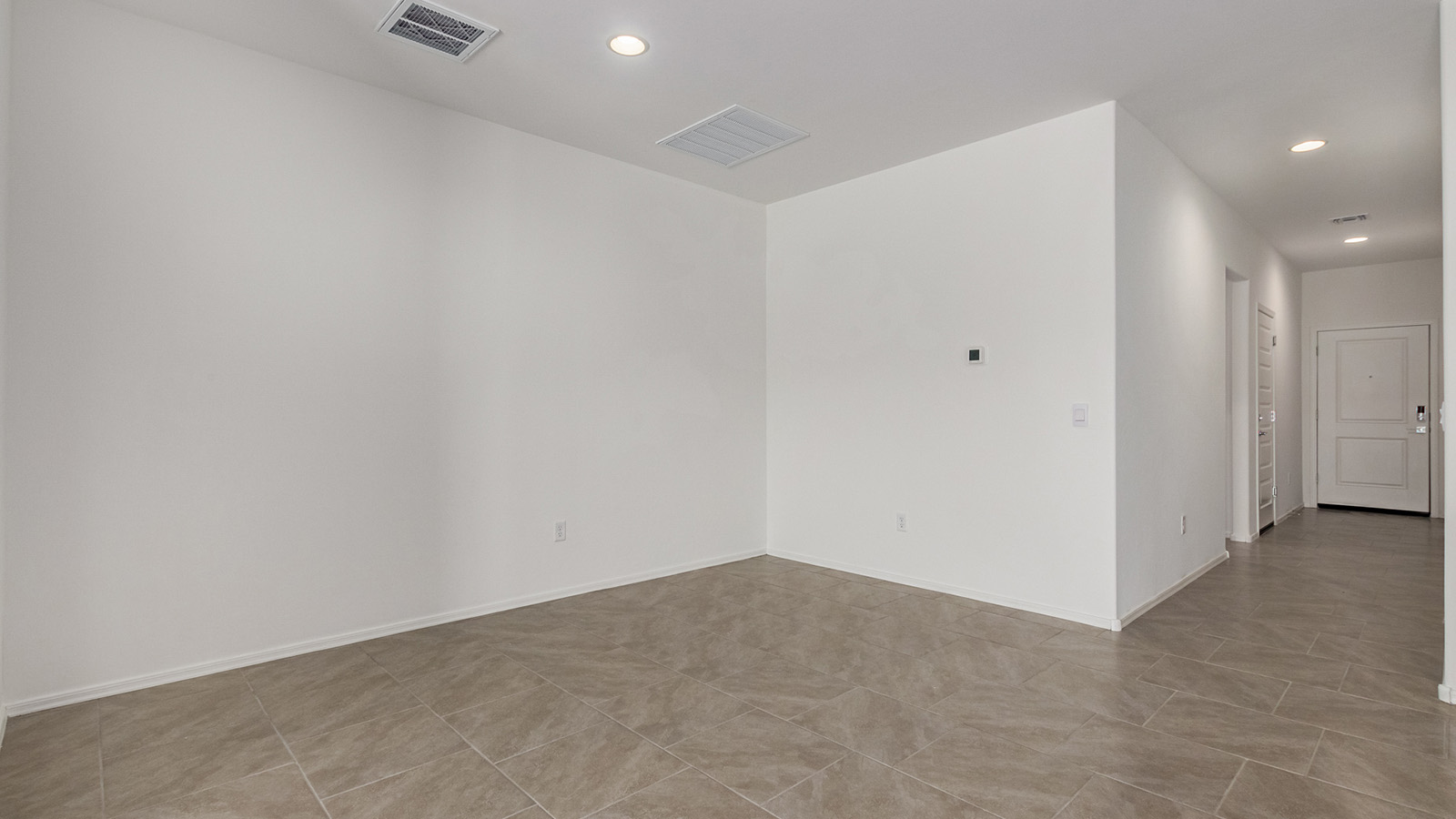 Discover The Easton at Barnett Village in Marana, Arizona – a spacious 1,701 sq. ft. single-story new home designed to offer both style and functionality for today’s modern family.  As you enter through the charming front porch, you’re welcomed into a thoughtful layout that makes every square foot count. Situated near the entrance you'll find the first bedroom, offering flexibility as a guest room, home office, or a cozy retreat.  Continuing down the hall, you’re led into the expansive great room, which flows seamlessly into the dining area and kitchen. This open-concept design ensures that the heart of the home is always connected, whether you’re preparing meals, dining, or relaxing with loved ones. The kitchen features sleek quartz countertops, a spacious center island, modern appliances, and a walk-in pantry that offers ample storage for all your cooking essentials.  The great room opens up to a covered patio, an ideal space to unwind and enjoy Arizona’s beautiful desert sunsets. Whether you’re hosting a weekend barbecue or enjoying a quiet evening outdoors, this patio extends your living space into the scenic surroundings of Barnett Village.  Just off the great room, a private hallway leads to the primary bedroom, which is a true retreat within the home. The primary suite is generously sized and includes a large walk-in closet and an en-suite bathroom, offering both luxury and convenience.   The Easton also features two additional bedrooms, well-positioned to share a full bathroom. These rooms are ideal for family members, providing comfortable living spaces with plenty of natural light.  For added convenience, the home includes a utility room and direct access to a two-car garage, making daily routines smoother and more efficient.  Designed with energy efficiency in mind, The Easton at Barnett Village is DOE Zero Energy Ready Home certified, ensuring both sustainability and savings.