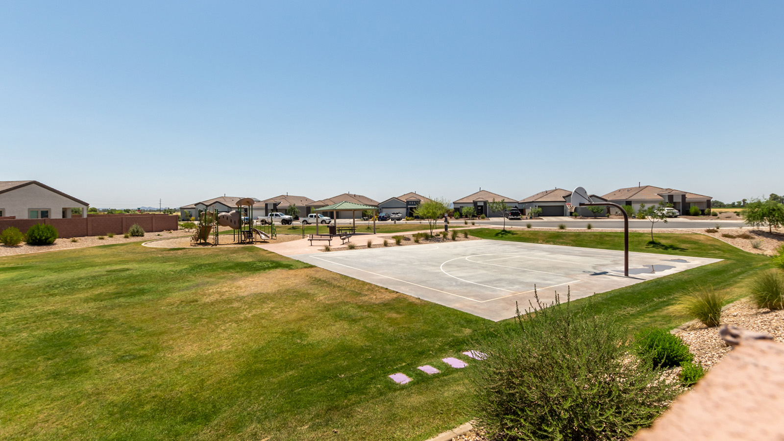 Discover The Easton at Barnett Village in Marana, Arizona – a spacious 1,701 sq. ft. single-story new home designed to offer both style and functionality for today’s modern family.  As you enter through the charming front porch, you’re welcomed into a thoughtful layout that makes every square foot count. Situated near the entrance you'll find the first bedroom, offering flexibility as a guest room, home office, or a cozy retreat.  Continuing down the hall, you’re led into the expansive great room, which flows seamlessly into the dining area and kitchen. This open-concept design ensures that the heart of the home is always connected, whether you’re preparing meals, dining, or relaxing with loved ones. The kitchen features sleek quartz countertops, a spacious center island, modern appliances, and a walk-in pantry that offers ample storage for all your cooking essentials.  The great room opens up to a covered patio, an ideal space to unwind and enjoy Arizona’s beautiful desert sunsets. Whether you’re hosting a weekend barbecue or enjoying a quiet evening outdoors, this patio extends your living space into the scenic surroundings of Barnett Village.  Just off the great room, a private hallway leads to the primary bedroom, which is a true retreat within the home. The primary suite is generously sized and includes a large walk-in closet and an en-suite bathroom, offering both luxury and convenience.   The Easton also features two additional bedrooms, well-positioned to share a full bathroom. These rooms are ideal for family members, providing comfortable living spaces with plenty of natural light.  For added convenience, the home includes a utility room and direct access to a two-car garage, making daily routines smoother and more efficient.  Designed with energy efficiency in mind, The Easton at Barnett Village is DOE Zero Energy Ready Home certified, ensuring both sustainability and savings.
