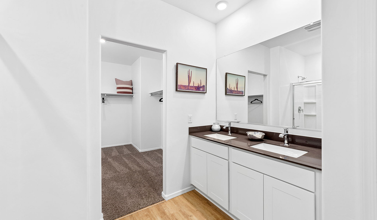 Welcome to The Harris at Barnett Village in Marana, Arizona – our beautifully designed home, offering 1,856 sq. ft. of modern living space that combines elegance with functionality.  Step through the inviting front porch and into a thoughtfully planned interior that begins with a welcoming entryway. This home features two of the four bedrooms near the entrance of the home, both sharing easy access to a full bathroom. These rooms are perfect for guests, children, or even a home office, providing comfort for various lifestyle needs.  As you continue through the spacious great room is revealed, the central hub of the home that seamlessly connects to the dining area and kitchen. The kitchen is a chef’s delight, complete with quartz countertops, large island with a breakfast bar, walk-in pantry, and state-of-the-art appliances.  Adjacent to the great room, a private hallway leads to the primary suite – a tranquil retreat within the home. The primary bedroom features a large walk-in closet and en-suite bathroom. Additionally, the suite offers direct access to a powder room, enhancing the convenience and privacy of this luxurious space.  The Harris also includes a utility room and a two-car garage adding to the home’s practical features, ensuring that daily routines are smooth and efficient.  Step outside to the covered patio, where you can unwind and take in the scenic beauty of Barnett Village. Whether you’re enjoying a quiet morning coffee or hosting a lively evening gathering, this outdoor space extends your living area and provides the perfect backdrop for Arizona’s desert landscapes.  Designed with energy efficiency, The Harris at Barnett Village is DOE Zero Energy Ready Home certified.  *Images shown are for reference only. They depict the sales model home and may not represent the actual home.