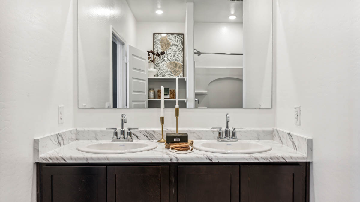 Explore The Denton at Barnett Village in Marana, Arizona – a spacious 1,615 sq. ft. single-story home designed to accommodate both comfort and convenience for modern living.    As you step through the front porch and into the welcoming entryway, you're immediately led into a thoughtfully designed space that maximizes every square foot. Near the front of the home, you’ll find two bedrooms and full bathroom.  Continuing through the home, you’ll enter the heart of The Denton – an expansive great room that seamlessly connects to the dining area and kitchen area. This open-concept space is perfect for entertaining or everyday family living, allowing for a fluid transition from cooking to dining to relaxation. The kitchen is equipped with sleek quartz countertops, modern appliances, a walk-in pantry, and an island that doubles as a breakfast bar, providing ample space for meal prep and casual dining.  Adjacent to the great room, you find the primary bedroom, a private sanctuary with a large walk-in closet and an en-suite bathroom.  The Denton also includes a utility room that adds functionality and storage options to the home, as well as direct access to a two-car garage.  Step outside from the great room to the covered patio – a perfect spot to enjoy Arizona’s beautiful weather year-round, whether you’re sipping your morning coffee or hosting an evening barbecue.  Designed with energy efficiency in mind, The Denton at Barnett Village is DOE Zero Energy Ready Home certified, ensuring long-term savings and a comfortable living environment.  *Images shown are for reference only. They depict the Denton model and may not represent the actual home.