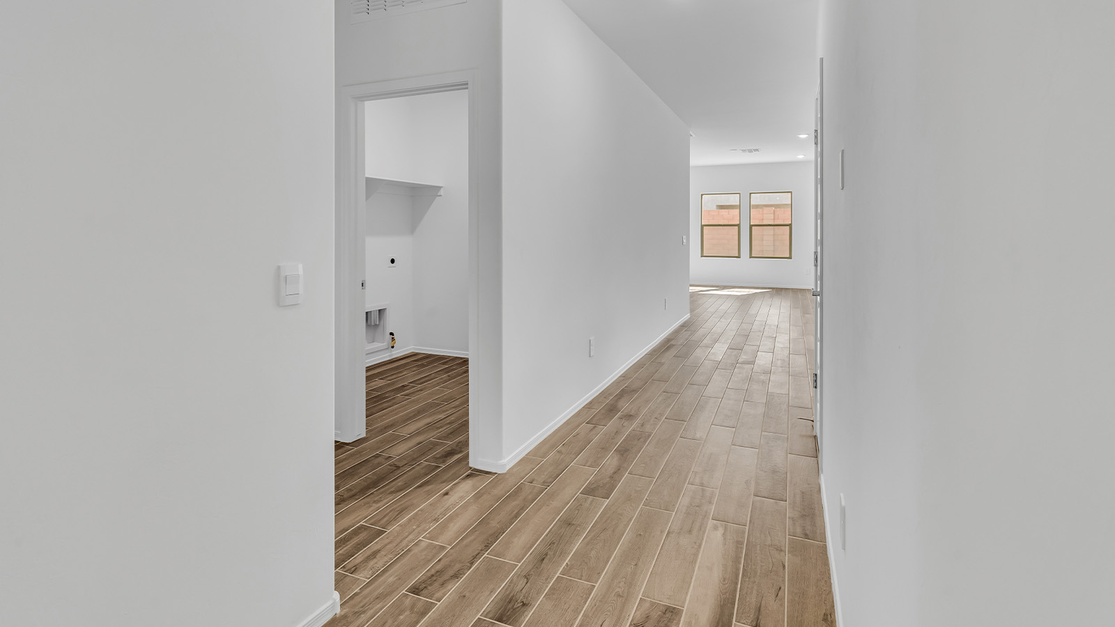 Step into The Cali at Barnett Village, Marana, Arizona – a perfect blend of comfort, modern living, and energy efficiency. This thoughtfully crafted one-story home spans 1,825 square feet and offers ample space featuring 4 bedrooms and 2 bathrooms, ideal for families of all sizes.  As you step through the front porch and into the welcoming entryway, you're immediately led into a thoughtfully designed space that maximizes every square foot. Near the entrance of the home you’ll find 2 bedrooms, ideal for guests or a home office, offering privacy and easy access to the main living areas.  Continuing through the home, you’ll enter the heart of The Cali – an expansive great room that seamlessly connects to the dining area and kitchen. This open-concept space is perfect for entertaining or everyday family living, allowing for a fluid transition from cooking to dining to relaxation. The kitchen is equipped with sleek quartz countertops, modern appliances, a pantry, and an island that doubles as a breakfast bar, providing ample space for meal prep and casual dining.  The primary bedroom, located at the rear of the home, provides a peaceful retreat with a private ensuite bathroom and a generous walk-in closet. The additional four bedrooms are positioned at the front of the house, offering versatility for use as guest rooms, a home office, or children’s bedrooms.  The Cali floor plan offers the option of an extended covered back patio. Whether it’s morning coffee or evening relaxation, this outdoor space extends your living area into the serene landscape of Barnett Village.  Designed with energy efficiency in mind, The Cali at Barnett Village is DOE Zero Energy Ready Home certified, ensuring long-term savings and a comfortable living environment.