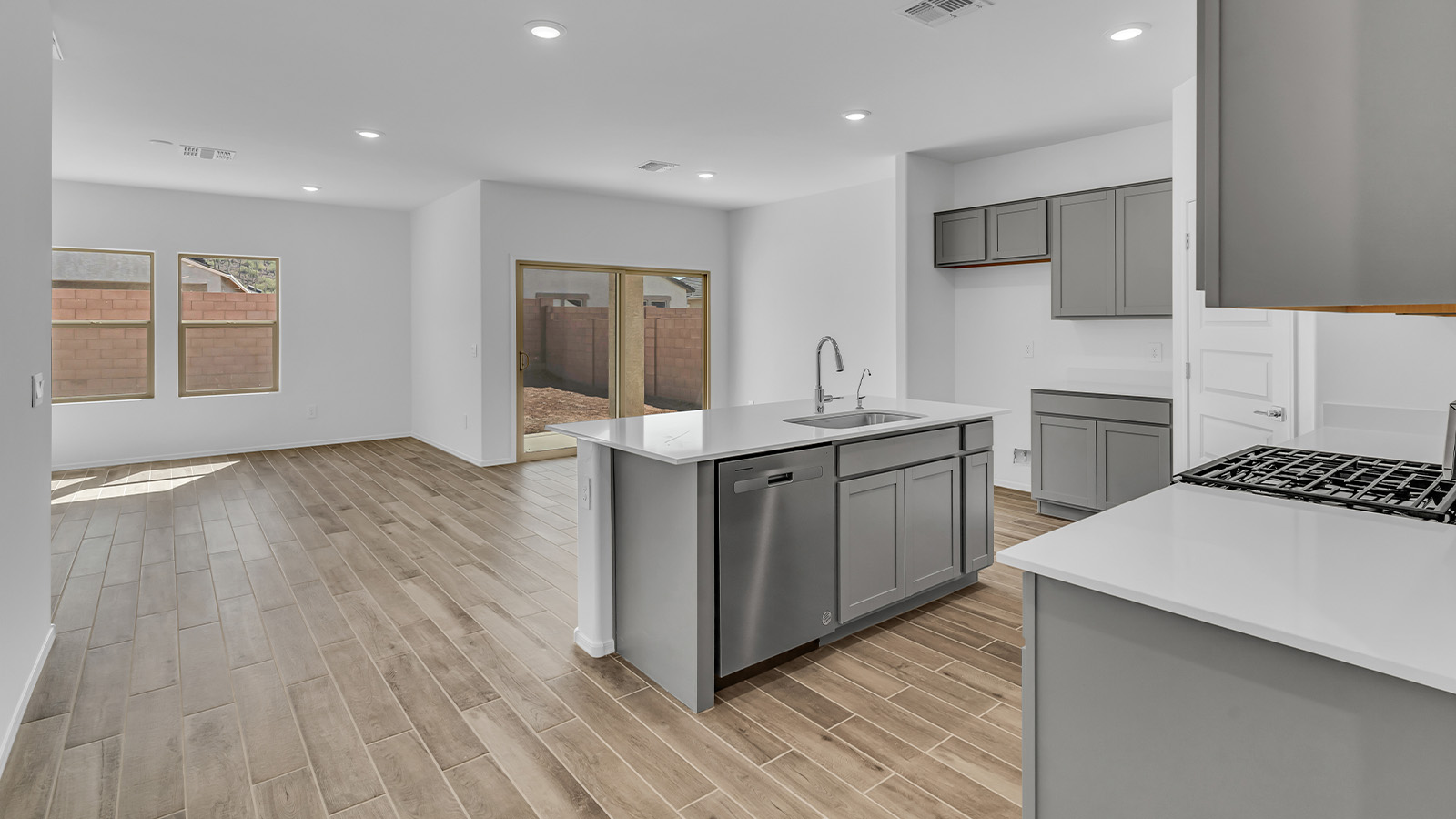 Step into The Cali at Barnett Village, Marana, Arizona – a perfect blend of comfort, modern living, and energy efficiency. This thoughtfully crafted one-story home spans 1,825 square feet and offers ample space featuring 4 bedrooms and 2 bathrooms, ideal for families of all sizes.  As you step through the front porch and into the welcoming entryway, you're immediately led into a thoughtfully designed space that maximizes every square foot. Near the entrance of the home you’ll find 2 bedrooms, ideal for guests or a home office, offering privacy and easy access to the main living areas.  Continuing through the home, you’ll enter the heart of The Cali – an expansive great room that seamlessly connects to the dining area and kitchen. This open-concept space is perfect for entertaining or everyday family living, allowing for a fluid transition from cooking to dining to relaxation. The kitchen is equipped with sleek quartz countertops, modern appliances, a pantry, and an island that doubles as a breakfast bar, providing ample space for meal prep and casual dining.  The primary bedroom, located at the rear of the home, provides a peaceful retreat with a private ensuite bathroom and a generous walk-in closet. The additional four bedrooms are positioned at the front of the house, offering versatility for use as guest rooms, a home office, or children’s bedrooms.  The Cali floor plan offers the option of an extended covered back patio. Whether it’s morning coffee or evening relaxation, this outdoor space extends your living area into the serene landscape of Barnett Village.  Designed with energy efficiency in mind, The Cali at Barnett Village is DOE Zero Energy Ready Home certified, ensuring long-term savings and a comfortable living environment.