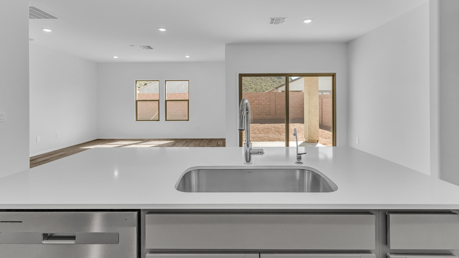 Step into The Cali at Barnett Village, Marana, Arizona – a perfect blend of comfort, modern living, and energy efficiency. This thoughtfully crafted one-story home spans 1,825 square feet and offers ample space featuring 4 bedrooms and 2 bathrooms, ideal for families of all sizes.  As you step through the front porch and into the welcoming entryway, you're immediately led into a thoughtfully designed space that maximizes every square foot. Near the entrance of the home you’ll find 2 bedrooms, ideal for guests or a home office, offering privacy and easy access to the main living areas.  Continuing through the home, you’ll enter the heart of The Cali – an expansive great room that seamlessly connects to the dining area and kitchen. This open-concept space is perfect for entertaining or everyday family living, allowing for a fluid transition from cooking to dining to relaxation. The kitchen is equipped with sleek quartz countertops, modern appliances, a pantry, and an island that doubles as a breakfast bar, providing ample space for meal prep and casual dining.  The primary bedroom, located at the rear of the home, provides a peaceful retreat with a private ensuite bathroom and a generous walk-in closet. The additional four bedrooms are positioned at the front of the house, offering versatility for use as guest rooms, a home office, or children’s bedrooms.  The Cali floor plan offers the option of an extended covered back patio. Whether it’s morning coffee or evening relaxation, this outdoor space extends your living area into the serene landscape of Barnett Village.  Designed with energy efficiency in mind, The Cali at Barnett Village is DOE Zero Energy Ready Home certified, ensuring long-term savings and a comfortable living environment.