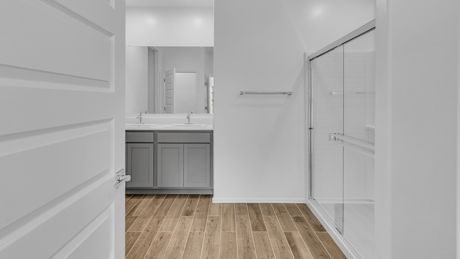 Step into The Cali at Barnett Village, Marana, Arizona – a perfect blend of comfort, modern living, and energy efficiency. This thoughtfully crafted one-story home spans 1,825 square feet and offers ample space featuring 4 bedrooms and 2 bathrooms, ideal for families of all sizes.  As you step through the front porch and into the welcoming entryway, you're immediately led into a thoughtfully designed space that maximizes every square foot. Near the entrance of the home you’ll find 2 bedrooms, ideal for guests or a home office, offering privacy and easy access to the main living areas.  Continuing through the home, you’ll enter the heart of The Cali – an expansive great room that seamlessly connects to the dining area and kitchen. This open-concept space is perfect for entertaining or everyday family living, allowing for a fluid transition from cooking to dining to relaxation. The kitchen is equipped with sleek quartz countertops, modern appliances, a pantry, and an island that doubles as a breakfast bar, providing ample space for meal prep and casual dining.  The primary bedroom, located at the rear of the home, provides a peaceful retreat with a private ensuite bathroom and a generous walk-in closet. The additional four bedrooms are positioned at the front of the house, offering versatility for use as guest rooms, a home office, or children’s bedrooms.  The Cali floor plan offers the option of an extended covered back patio. Whether it’s morning coffee or evening relaxation, this outdoor space extends your living area into the serene landscape of Barnett Village.  Designed with energy efficiency in mind, The Cali at Barnett Village is DOE Zero Energy Ready Home certified, ensuring long-term savings and a comfortable living environment.