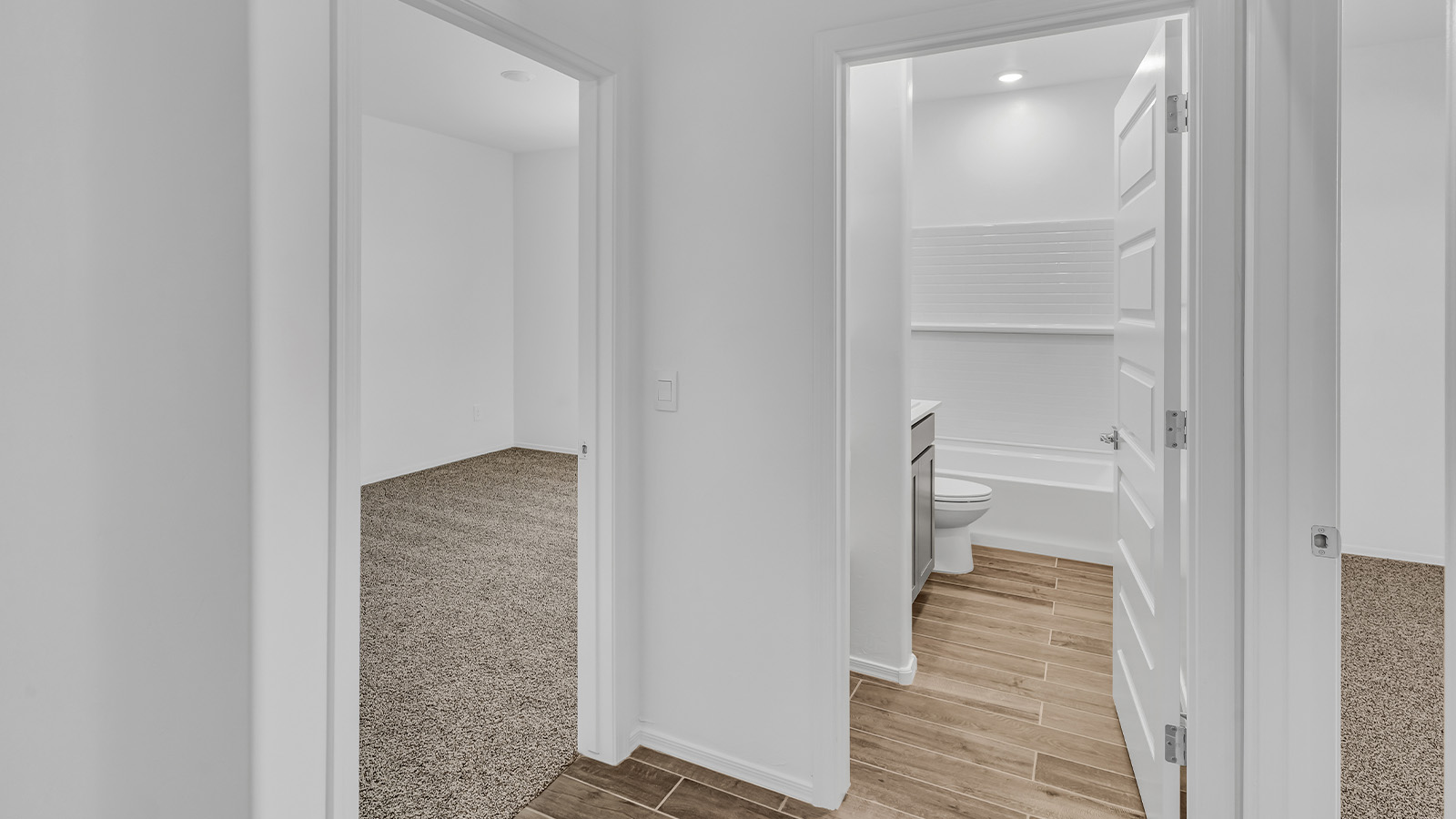 Step into The Cali at Barnett Village, Marana, Arizona – a perfect blend of comfort, modern living, and energy efficiency. This thoughtfully crafted one-story home spans 1,825 square feet and offers ample space featuring 4 bedrooms and 2 bathrooms, ideal for families of all sizes.  As you step through the front porch and into the welcoming entryway, you're immediately led into a thoughtfully designed space that maximizes every square foot. Near the entrance of the home you’ll find 2 bedrooms, ideal for guests or a home office, offering privacy and easy access to the main living areas.  Continuing through the home, you’ll enter the heart of The Cali – an expansive great room that seamlessly connects to the dining area and kitchen. This open-concept space is perfect for entertaining or everyday family living, allowing for a fluid transition from cooking to dining to relaxation. The kitchen is equipped with sleek quartz countertops, modern appliances, a pantry, and an island that doubles as a breakfast bar, providing ample space for meal prep and casual dining.  The primary bedroom, located at the rear of the home, provides a peaceful retreat with a private ensuite bathroom and a generous walk-in closet. The additional four bedrooms are positioned at the front of the house, offering versatility for use as guest rooms, a home office, or children’s bedrooms.  The Cali floor plan offers the option of an extended covered back patio. Whether it’s morning coffee or evening relaxation, this outdoor space extends your living area into the serene landscape of Barnett Village.  Designed with energy efficiency in mind, The Cali at Barnett Village is DOE Zero Energy Ready Home certified, ensuring long-term savings and a comfortable living environment.