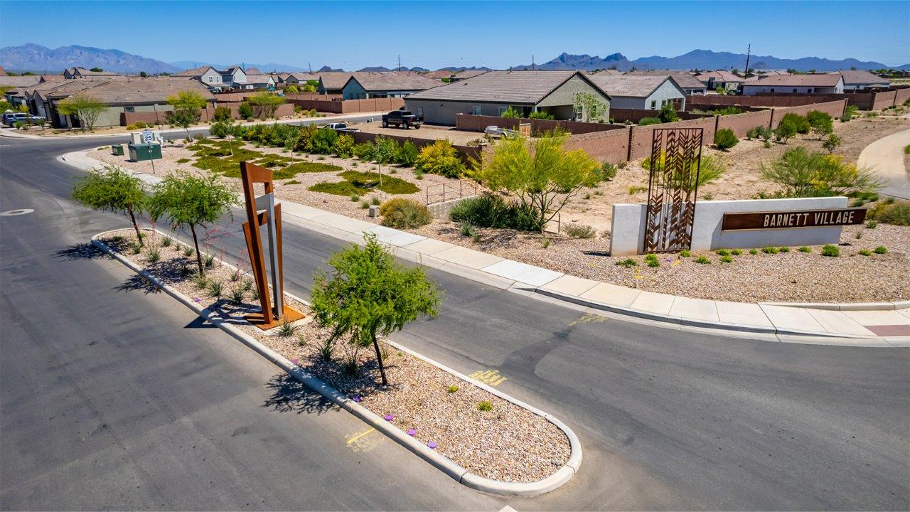 Step into The Cali at Barnett Village, Marana, Arizona – a perfect blend of comfort, modern living, and energy efficiency. This thoughtfully crafted one-story home spans 1,825 square feet and offers ample space featuring 4 bedrooms and 2 bathrooms, ideal for families of all sizes.  As you step through the front porch and into the welcoming entryway, you're immediately led into a thoughtfully designed space that maximizes every square foot. Near the entrance of the home you’ll find 2 bedrooms, ideal for guests or a home office, offering privacy and easy access to the main living areas.  Continuing through the home, you’ll enter the heart of The Cali – an expansive great room that seamlessly connects to the dining area and kitchen. This open-concept space is perfect for entertaining or everyday family living, allowing for a fluid transition from cooking to dining to relaxation. The kitchen is equipped with sleek quartz countertops, modern appliances, a pantry, and an island that doubles as a breakfast bar, providing ample space for meal prep and casual dining.  The primary bedroom, located at the rear of the home, provides a peaceful retreat with a private ensuite bathroom and a generous walk-in closet. The additional four bedrooms are positioned at the front of the house, offering versatility for use as guest rooms, a home office, or children’s bedrooms.  The Cali floor plan offers the option of an extended covered back patio. Whether it’s morning coffee or evening relaxation, this outdoor space extends your living area into the serene landscape of Barnett Village.  Designed with energy efficiency in mind, The Cali at Barnett Village is DOE Zero Energy Ready Home certified, ensuring long-term savings and a comfortable living environment.
