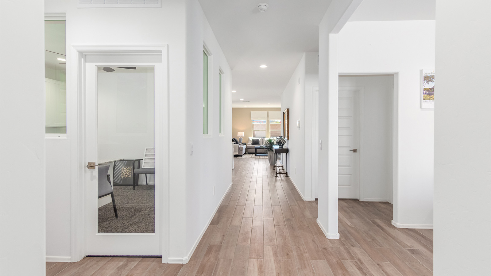 Step into The Cali at Barnett Village, Marana, Arizona – a perfect blend of comfort, modern living, and energy efficiency. This thoughtfully crafted one-story home spans 1,825 square feet and offers ample space featuring 4 bedrooms and 2 bathrooms, ideal for families of all sizes.  As you step through the front porch and into the welcoming entryway, you're immediately led into a thoughtfully designed space that maximizes every square foot. Near the entrance of the home you’ll find 2 bedrooms, ideal for guests or a home office, offering privacy and easy access to the main living areas.  Continuing through the home, you’ll enter the heart of The Cali – an expansive great room that seamlessly connects to the dining area and kitchen. This open-concept space is perfect for entertaining or everyday family living, allowing for a fluid transition from cooking to dining to relaxation. The kitchen is equipped with sleek quartz countertops, modern appliances, a pantry, and an island that doubles as a breakfast bar, providing ample space for meal prep and casual dining.  The primary bedroom, located at the rear of the home, provides a peaceful retreat with a private ensuite bathroom and a generous walk-in closet. The additional four bedrooms are positioned at the front of the house, offering versatility for use as guest rooms, a home office, or children’s bedrooms.  The Cali floor plan offers the option of an extended covered back patio. Whether it’s morning coffee or evening relaxation, this outdoor space extends your living area into the serene landscape of Barnett Village.  Designed with energy efficiency in mind, The Cali at Barnett Village is DOE Zero Energy Ready Home certified, ensuring long-term savings and a comfortable living environment.