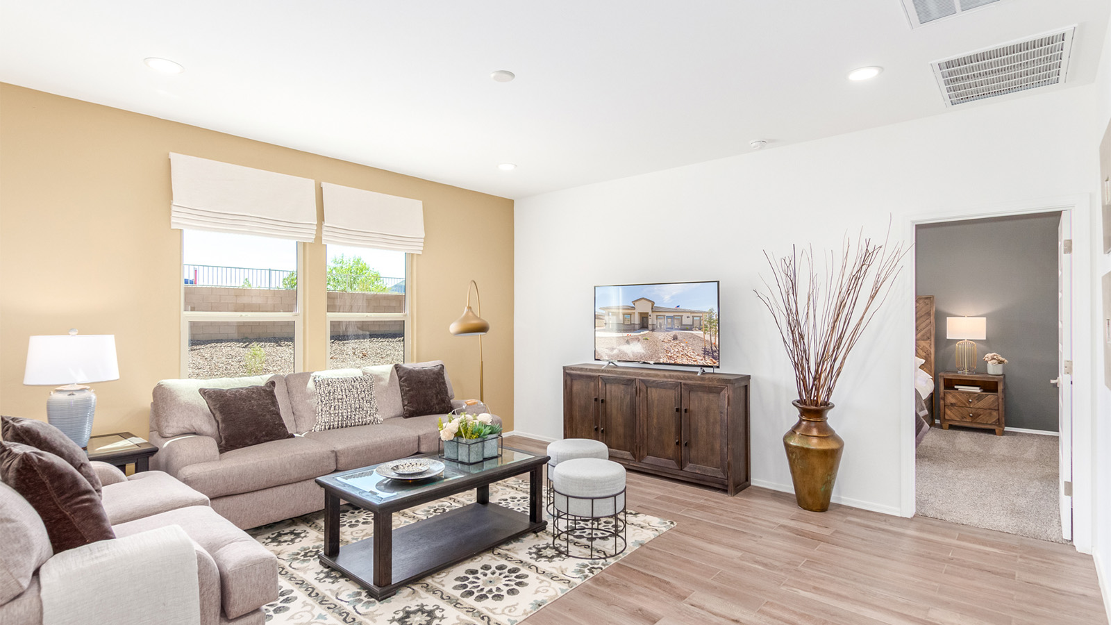 Step into The Cali at Barnett Village, Marana, Arizona – a perfect blend of comfort, modern living, and energy efficiency. This thoughtfully crafted one-story home spans 1,825 square feet and offers ample space featuring 4 bedrooms and 2 bathrooms, ideal for families of all sizes.  As you step through the front porch and into the welcoming entryway, you're immediately led into a thoughtfully designed space that maximizes every square foot. Near the entrance of the home you’ll find 2 bedrooms, ideal for guests or a home office, offering privacy and easy access to the main living areas.  Continuing through the home, you’ll enter the heart of The Cali – an expansive great room that seamlessly connects to the dining area and kitchen. This open-concept space is perfect for entertaining or everyday family living, allowing for a fluid transition from cooking to dining to relaxation. The kitchen is equipped with sleek quartz countertops, modern appliances, a pantry, and an island that doubles as a breakfast bar, providing ample space for meal prep and casual dining.  The primary bedroom, located at the rear of the home, provides a peaceful retreat with a private ensuite bathroom and a generous walk-in closet. The additional four bedrooms are positioned at the front of the house, offering versatility for use as guest rooms, a home office, or children’s bedrooms.  The Cali floor plan offers the option of an extended covered back patio. Whether it’s morning coffee or evening relaxation, this outdoor space extends your living area into the serene landscape of Barnett Village.  Designed with energy efficiency in mind, The Cali at Barnett Village is DOE Zero Energy Ready Home certified, ensuring long-term savings and a comfortable living environment.