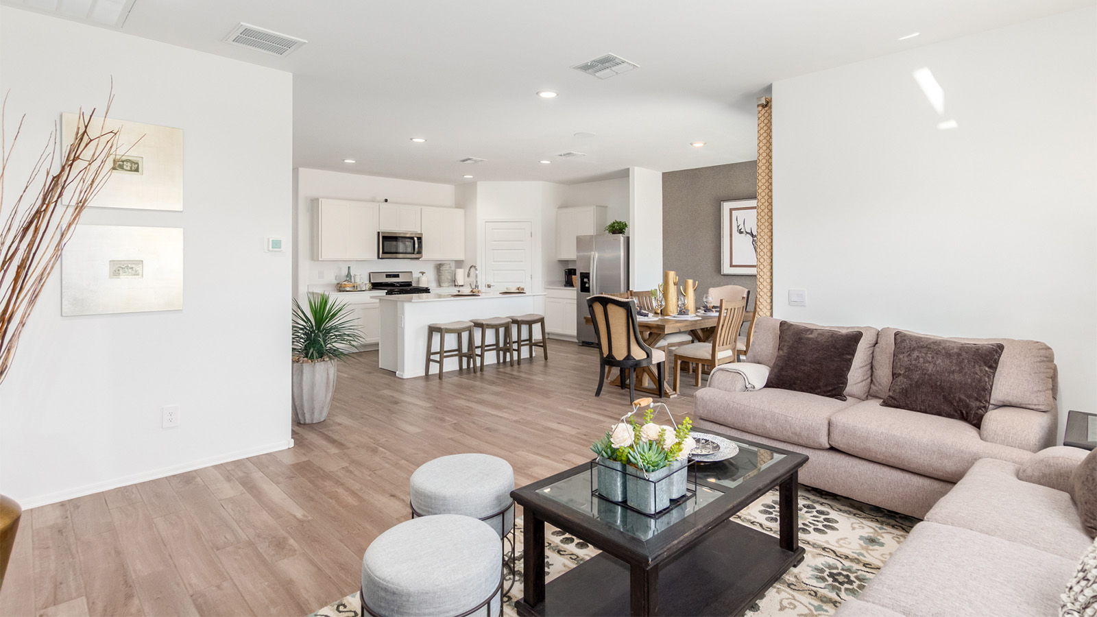 Step into The Cali at Barnett Village, Marana, Arizona – a perfect blend of comfort, modern living, and energy efficiency. This thoughtfully crafted one-story home spans 1,825 square feet and offers ample space featuring 4 bedrooms and 2 bathrooms, ideal for families of all sizes.  As you step through the front porch and into the welcoming entryway, you're immediately led into a thoughtfully designed space that maximizes every square foot. Near the entrance of the home you’ll find 2 bedrooms, ideal for guests or a home office, offering privacy and easy access to the main living areas.  Continuing through the home, you’ll enter the heart of The Cali – an expansive great room that seamlessly connects to the dining area and kitchen. This open-concept space is perfect for entertaining or everyday family living, allowing for a fluid transition from cooking to dining to relaxation. The kitchen is equipped with sleek quartz countertops, modern appliances, a pantry, and an island that doubles as a breakfast bar, providing ample space for meal prep and casual dining.  The primary bedroom, located at the rear of the home, provides a peaceful retreat with a private ensuite bathroom and a generous walk-in closet. The additional four bedrooms are positioned at the front of the house, offering versatility for use as guest rooms, a home office, or children’s bedrooms.  The Cali floor plan offers the option of an extended covered back patio. Whether it’s morning coffee or evening relaxation, this outdoor space extends your living area into the serene landscape of Barnett Village.  Designed with energy efficiency in mind, The Cali at Barnett Village is DOE Zero Energy Ready Home certified, ensuring long-term savings and a comfortable living environment.