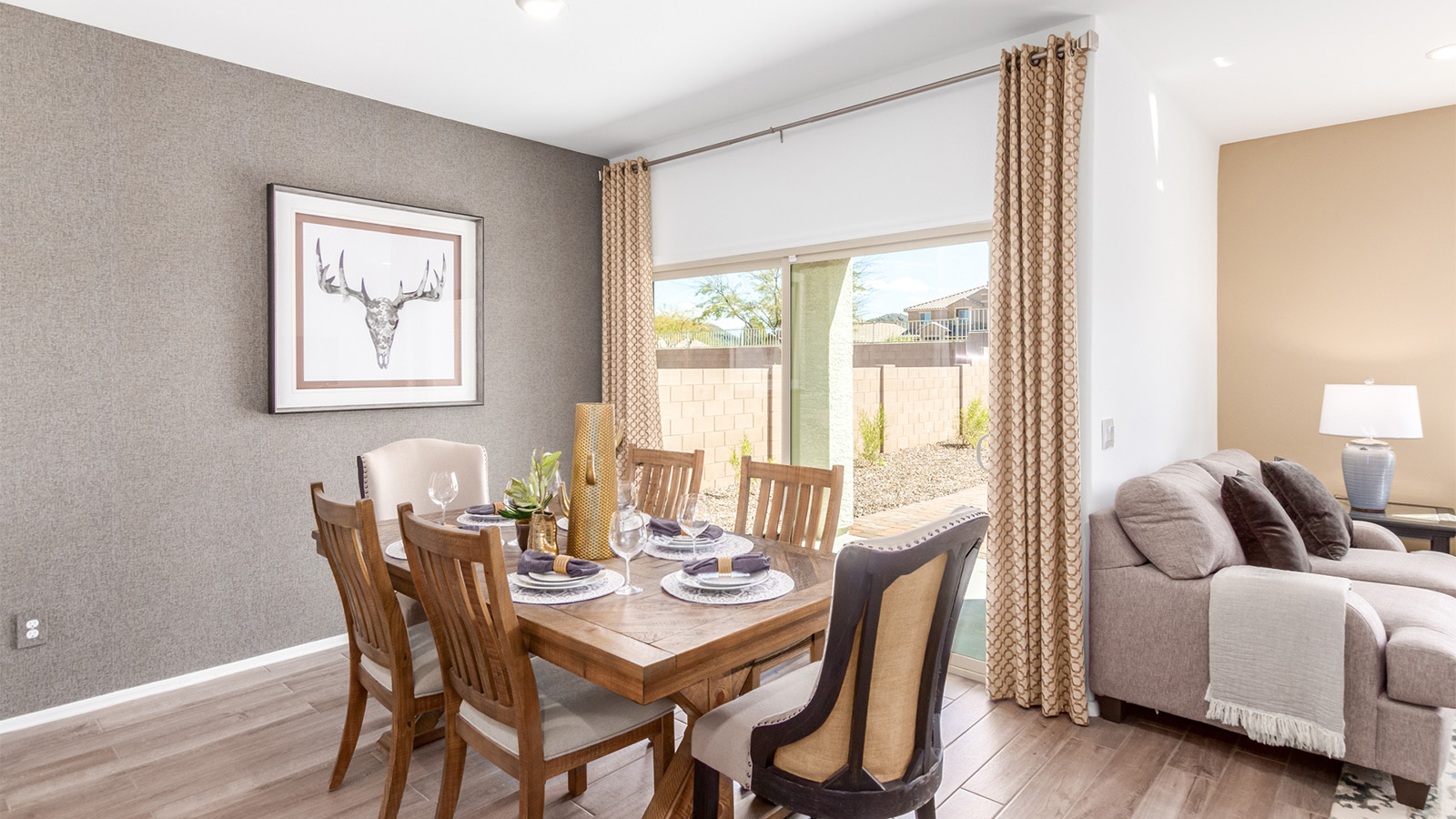 Step into The Cali at Barnett Village, Marana, Arizona – a perfect blend of comfort, modern living, and energy efficiency. This thoughtfully crafted one-story home spans 1,825 square feet and offers ample space featuring 4 bedrooms and 2 bathrooms, ideal for families of all sizes.  As you step through the front porch and into the welcoming entryway, you're immediately led into a thoughtfully designed space that maximizes every square foot. Near the entrance of the home you’ll find 2 bedrooms, ideal for guests or a home office, offering privacy and easy access to the main living areas.  Continuing through the home, you’ll enter the heart of The Cali – an expansive great room that seamlessly connects to the dining area and kitchen. This open-concept space is perfect for entertaining or everyday family living, allowing for a fluid transition from cooking to dining to relaxation. The kitchen is equipped with sleek quartz countertops, modern appliances, a pantry, and an island that doubles as a breakfast bar, providing ample space for meal prep and casual dining.  The primary bedroom, located at the rear of the home, provides a peaceful retreat with a private ensuite bathroom and a generous walk-in closet. The additional four bedrooms are positioned at the front of the house, offering versatility for use as guest rooms, a home office, or children’s bedrooms.  The Cali floor plan offers the option of an extended covered back patio. Whether it’s morning coffee or evening relaxation, this outdoor space extends your living area into the serene landscape of Barnett Village.  Designed with energy efficiency in mind, The Cali at Barnett Village is DOE Zero Energy Ready Home certified, ensuring long-term savings and a comfortable living environment.