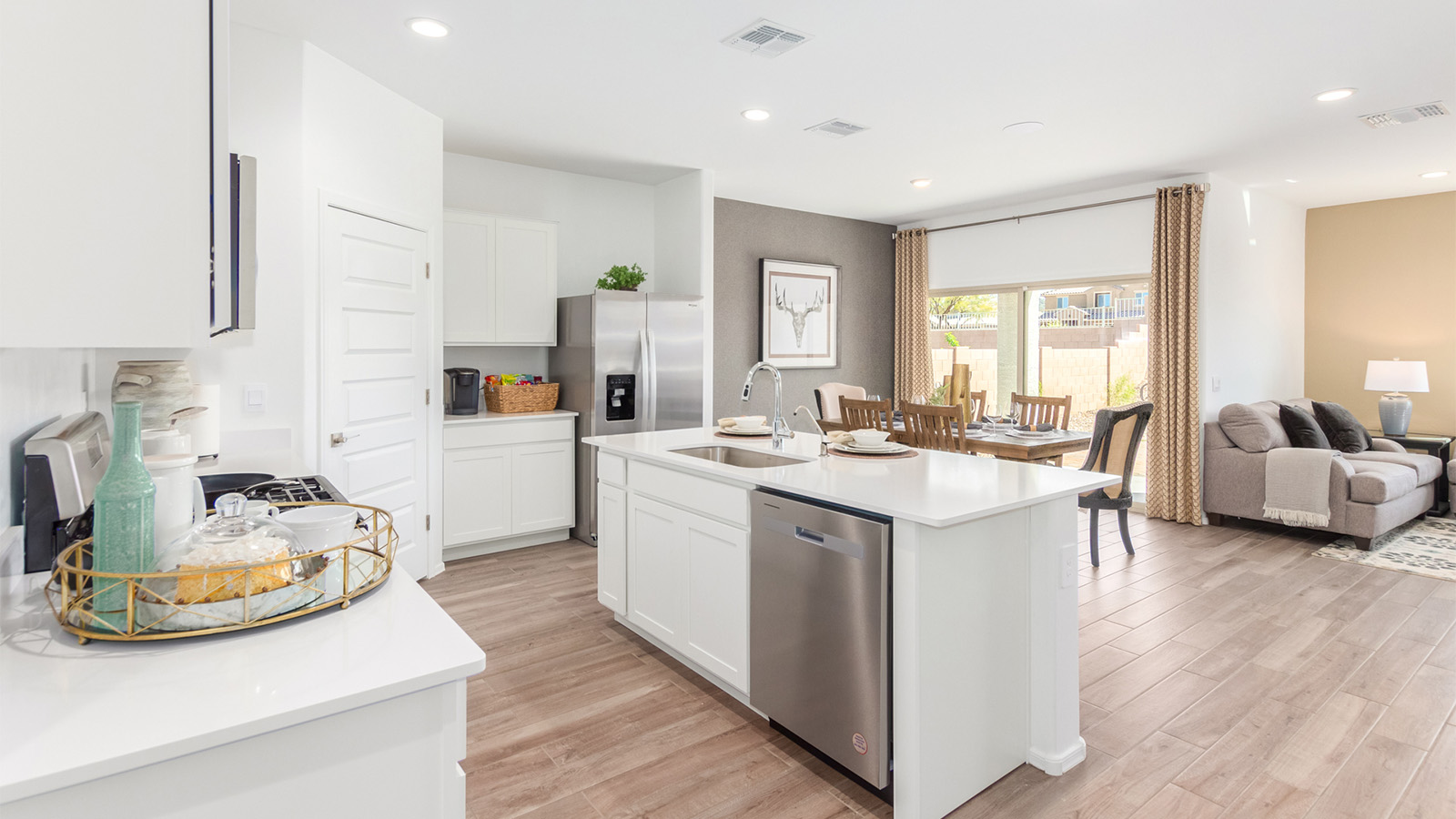 Step into The Cali at Barnett Village, Marana, Arizona – a perfect blend of comfort, modern living, and energy efficiency. This thoughtfully crafted one-story home spans 1,825 square feet and offers ample space featuring 4 bedrooms and 2 bathrooms, ideal for families of all sizes.  As you step through the front porch and into the welcoming entryway, you're immediately led into a thoughtfully designed space that maximizes every square foot. Near the entrance of the home you’ll find 2 bedrooms, ideal for guests or a home office, offering privacy and easy access to the main living areas.  Continuing through the home, you’ll enter the heart of The Cali – an expansive great room that seamlessly connects to the dining area and kitchen. This open-concept space is perfect for entertaining or everyday family living, allowing for a fluid transition from cooking to dining to relaxation. The kitchen is equipped with sleek quartz countertops, modern appliances, a pantry, and an island that doubles as a breakfast bar, providing ample space for meal prep and casual dining.  The primary bedroom, located at the rear of the home, provides a peaceful retreat with a private ensuite bathroom and a generous walk-in closet. The additional four bedrooms are positioned at the front of the house, offering versatility for use as guest rooms, a home office, or children’s bedrooms.  The Cali floor plan offers the option of an extended covered back patio. Whether it’s morning coffee or evening relaxation, this outdoor space extends your living area into the serene landscape of Barnett Village.  Designed with energy efficiency in mind, The Cali at Barnett Village is DOE Zero Energy Ready Home certified, ensuring long-term savings and a comfortable living environment.