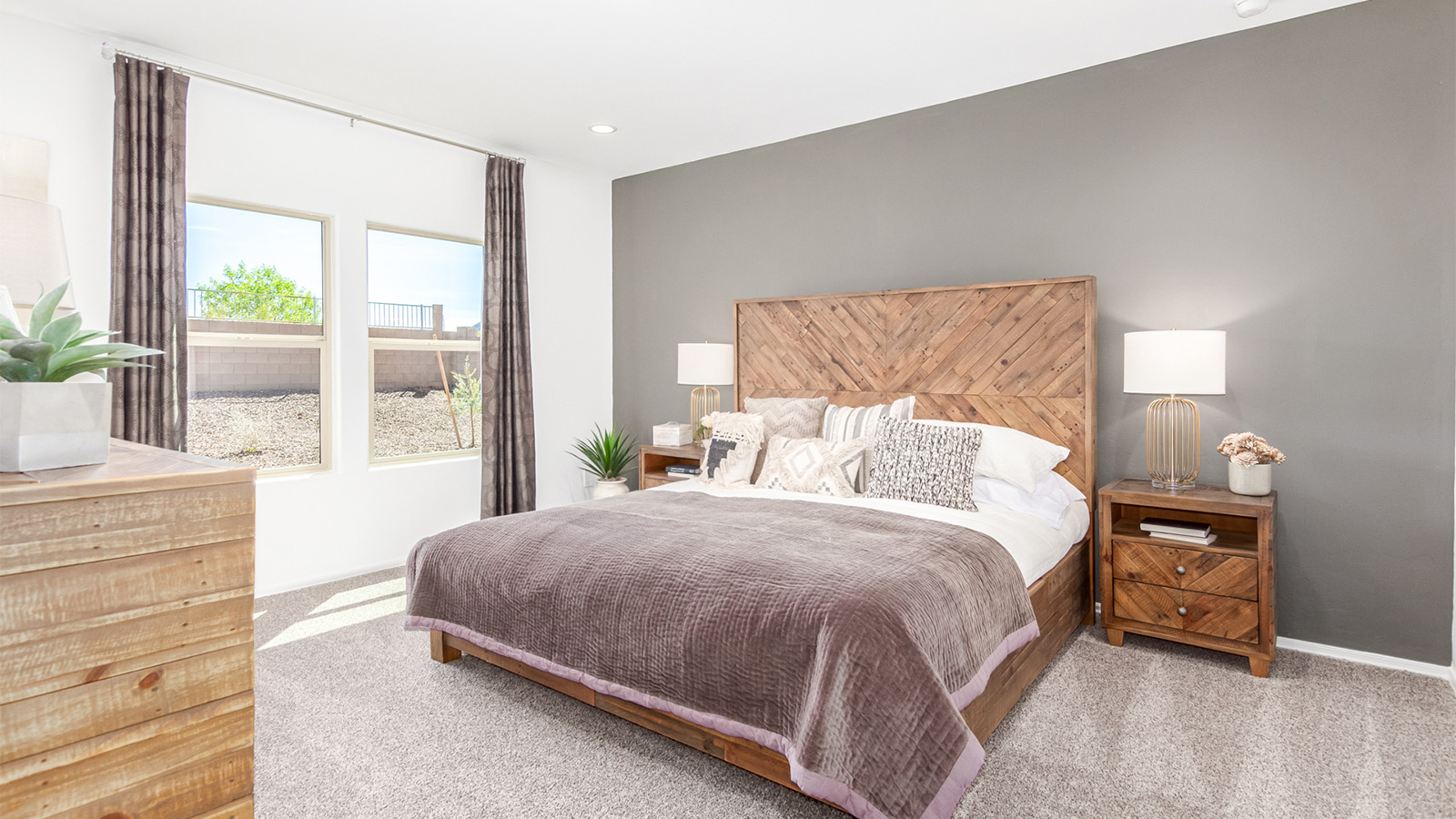 Step into The Cali at Barnett Village, Marana, Arizona – a perfect blend of comfort, modern living, and energy efficiency. This thoughtfully crafted one-story home spans 1,825 square feet and offers ample space featuring 4 bedrooms and 2 bathrooms, ideal for families of all sizes.  As you step through the front porch and into the welcoming entryway, you're immediately led into a thoughtfully designed space that maximizes every square foot. Near the entrance of the home you’ll find 2 bedrooms, ideal for guests or a home office, offering privacy and easy access to the main living areas.  Continuing through the home, you’ll enter the heart of The Cali – an expansive great room that seamlessly connects to the dining area and kitchen. This open-concept space is perfect for entertaining or everyday family living, allowing for a fluid transition from cooking to dining to relaxation. The kitchen is equipped with sleek quartz countertops, modern appliances, a pantry, and an island that doubles as a breakfast bar, providing ample space for meal prep and casual dining.  The primary bedroom, located at the rear of the home, provides a peaceful retreat with a private ensuite bathroom and a generous walk-in closet. The additional four bedrooms are positioned at the front of the house, offering versatility for use as guest rooms, a home office, or children’s bedrooms.  The Cali floor plan offers the option of an extended covered back patio. Whether it’s morning coffee or evening relaxation, this outdoor space extends your living area into the serene landscape of Barnett Village.  Designed with energy efficiency in mind, The Cali at Barnett Village is DOE Zero Energy Ready Home certified, ensuring long-term savings and a comfortable living environment.