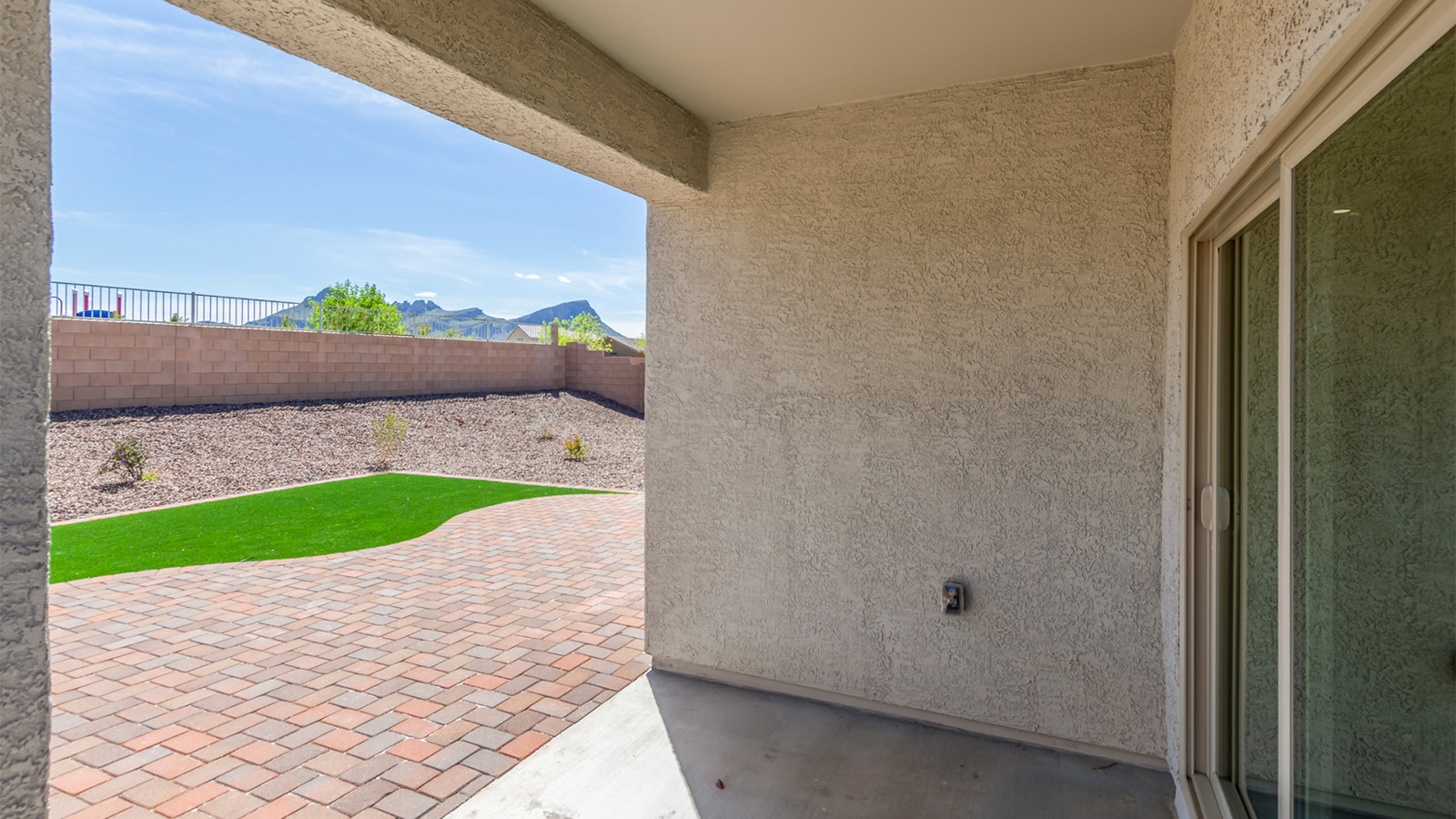Step into The Cali at Barnett Village, Marana, Arizona – a perfect blend of comfort, modern living, and energy efficiency. This thoughtfully crafted one-story home spans 1,825 square feet and offers ample space featuring 4 bedrooms and 2 bathrooms, ideal for families of all sizes.  As you step through the front porch and into the welcoming entryway, you're immediately led into a thoughtfully designed space that maximizes every square foot. Near the entrance of the home you’ll find 2 bedrooms, ideal for guests or a home office, offering privacy and easy access to the main living areas.  Continuing through the home, you’ll enter the heart of The Cali – an expansive great room that seamlessly connects to the dining area and kitchen. This open-concept space is perfect for entertaining or everyday family living, allowing for a fluid transition from cooking to dining to relaxation. The kitchen is equipped with sleek quartz countertops, modern appliances, a pantry, and an island that doubles as a breakfast bar, providing ample space for meal prep and casual dining.  The primary bedroom, located at the rear of the home, provides a peaceful retreat with a private ensuite bathroom and a generous walk-in closet. The additional four bedrooms are positioned at the front of the house, offering versatility for use as guest rooms, a home office, or children’s bedrooms.  The Cali floor plan offers the option of an extended covered back patio. Whether it’s morning coffee or evening relaxation, this outdoor space extends your living area into the serene landscape of Barnett Village.  Designed with energy efficiency in mind, The Cali at Barnett Village is DOE Zero Energy Ready Home certified, ensuring long-term savings and a comfortable living environment.