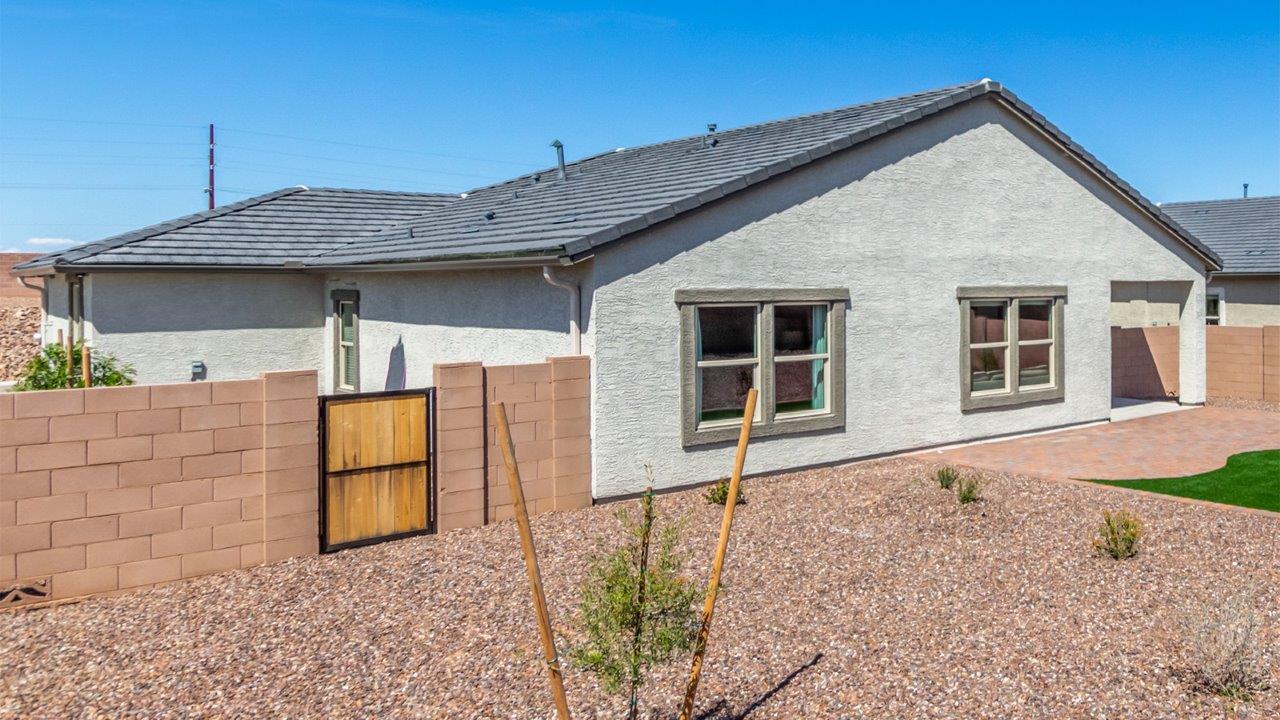 Step into The Cali at Barnett Village, Marana, Arizona – a perfect blend of comfort, modern living, and energy efficiency. This thoughtfully crafted one-story home spans 1,825 square feet and offers ample space featuring 4 bedrooms and 2 bathrooms, ideal for families of all sizes.  As you step through the front porch and into the welcoming entryway, you're immediately led into a thoughtfully designed space that maximizes every square foot. Near the entrance of the home you’ll find 2 bedrooms, ideal for guests or a home office, offering privacy and easy access to the main living areas.  Continuing through the home, you’ll enter the heart of The Cali – an expansive great room that seamlessly connects to the dining area and kitchen. This open-concept space is perfect for entertaining or everyday family living, allowing for a fluid transition from cooking to dining to relaxation. The kitchen is equipped with sleek quartz countertops, modern appliances, a pantry, and an island that doubles as a breakfast bar, providing ample space for meal prep and casual dining.  The primary bedroom, located at the rear of the home, provides a peaceful retreat with a private ensuite bathroom and a generous walk-in closet. The additional four bedrooms are positioned at the front of the house, offering versatility for use as guest rooms, a home office, or children’s bedrooms.  The Cali floor plan offers the option of an extended covered back patio. Whether it’s morning coffee or evening relaxation, this outdoor space extends your living area into the serene landscape of Barnett Village.  Designed with energy efficiency in mind, The Cali at Barnett Village is DOE Zero Energy Ready Home certified, ensuring long-term savings and a comfortable living environment.