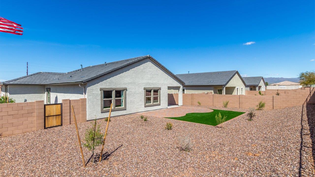 Step into The Cali at Barnett Village, Marana, Arizona – a perfect blend of comfort, modern living, and energy efficiency. This thoughtfully crafted one-story home spans 1,825 square feet and offers ample space featuring 4 bedrooms and 2 bathrooms, ideal for families of all sizes.  As you step through the front porch and into the welcoming entryway, you're immediately led into a thoughtfully designed space that maximizes every square foot. Near the entrance of the home you’ll find 2 bedrooms, ideal for guests or a home office, offering privacy and easy access to the main living areas.  Continuing through the home, you’ll enter the heart of The Cali – an expansive great room that seamlessly connects to the dining area and kitchen. This open-concept space is perfect for entertaining or everyday family living, allowing for a fluid transition from cooking to dining to relaxation. The kitchen is equipped with sleek quartz countertops, modern appliances, a pantry, and an island that doubles as a breakfast bar, providing ample space for meal prep and casual dining.  The primary bedroom, located at the rear of the home, provides a peaceful retreat with a private ensuite bathroom and a generous walk-in closet. The additional four bedrooms are positioned at the front of the house, offering versatility for use as guest rooms, a home office, or children’s bedrooms.  The Cali floor plan offers the option of an extended covered back patio. Whether it’s morning coffee or evening relaxation, this outdoor space extends your living area into the serene landscape of Barnett Village.  Designed with energy efficiency in mind, The Cali at Barnett Village is DOE Zero Energy Ready Home certified, ensuring long-term savings and a comfortable living environment.
