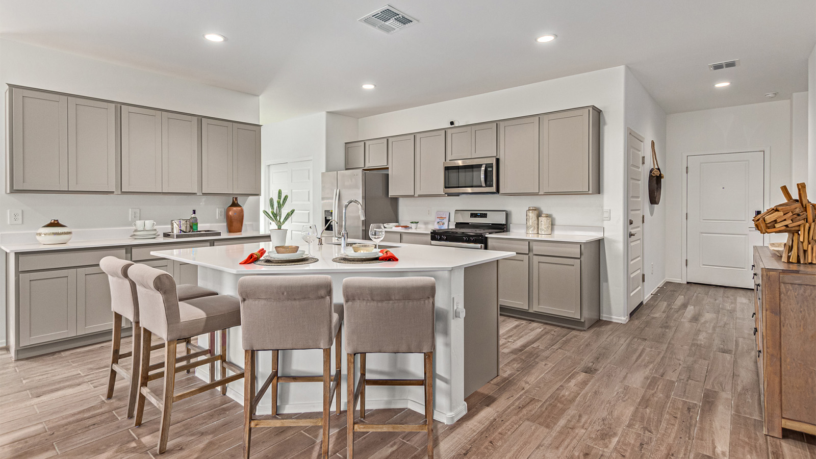 Step into The Kingston at Barnett Village, Marana, Arizona – a perfect blend of comfort, modern living, and energy efficiency. This thoughtfully crafted one-story home spans 2,068 square feet and offers four bedrooms and two bathrooms, ideal for families of all sizes.  The open-concept design features a spacious great room that effortlessly connects with the kitchen and dining area, creating an inviting central hub for everyday living and entertaining. The kitchen is equipped with contemporary appliances and a pantry, offering ample storage and convenience for meal preparation.  The primary bedroom, located at the rear of the home, provides a peaceful retreat with a private ensuite bathroom and a generous walk-in closet. The additional three bedrooms are positioned at the front of the house, offering versatility for use as guest rooms, a home office, or children’s bedrooms. Step outside to the covered patio, a perfect spot to enjoy the beautiful Arizona weather, whether for morning coffee or evening relaxation.  The Kingston also boasts a covered patio, perfect for enjoying Arizona’s beautiful desert evenings. Whether it’s morning coffee or evening relaxation, this outdoor space extends your living area into the serene landscape of Barnett Village.  Built with energy efficiency as a priority, the Kingston includes smart home technology, which not only simplifies daily living but also helps reduce utility costs. A two-car garage provides ample parking and additional storage space, enhancing the home’s functionality.  *Images shown are for reference only. They depict The Kingston sales model home and may not represent the actual home.