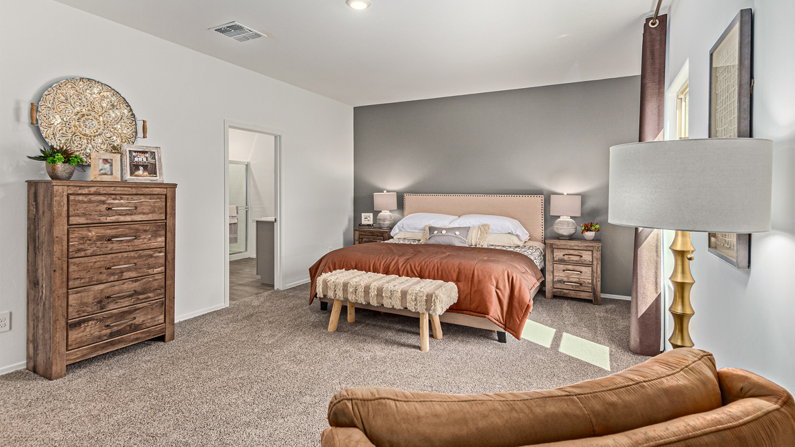 Step into The Kingston at Barnett Village, Marana, Arizona – a perfect blend of comfort, modern living, and energy efficiency. This thoughtfully crafted one-story home spans 2,068 square feet and offers four bedrooms and two bathrooms, ideal for families of all sizes.  The open-concept design features a spacious great room that effortlessly connects with the kitchen and dining area, creating an inviting central hub for everyday living and entertaining. The kitchen is equipped with contemporary appliances and a pantry, offering ample storage and convenience for meal preparation.  The primary bedroom, located at the rear of the home, provides a peaceful retreat with a private ensuite bathroom and a generous walk-in closet. The additional three bedrooms are positioned at the front of the house, offering versatility for use as guest rooms, a home office, or children’s bedrooms. Step outside to the covered patio, a perfect spot to enjoy the beautiful Arizona weather, whether for morning coffee or evening relaxation.  The Kingston also boasts a covered patio, perfect for enjoying Arizona’s beautiful desert evenings. Whether it’s morning coffee or evening relaxation, this outdoor space extends your living area into the serene landscape of Barnett Village.  Built with energy efficiency as a priority, the Kingston includes smart home technology, which not only simplifies daily living but also helps reduce utility costs. A two-car garage provides ample parking and additional storage space, enhancing the home’s functionality.  *Images shown are for reference only. They depict The Kingston sales model home and may not represent the actual home.