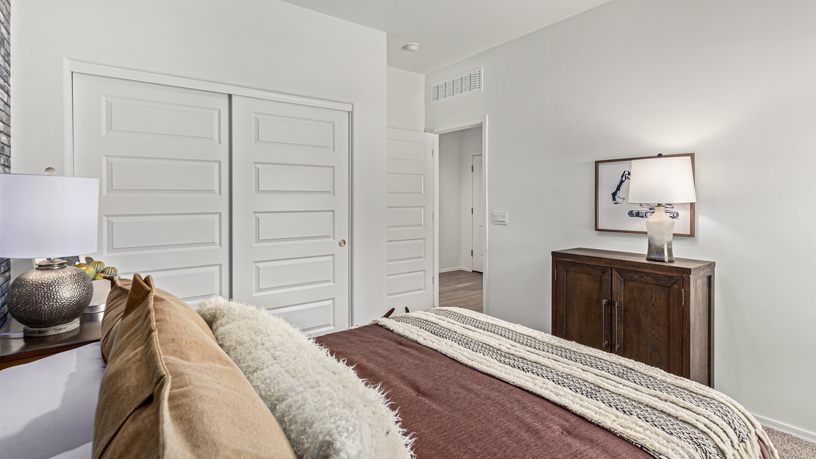 Step into The Kingston at Barnett Village, Marana, Arizona – a perfect blend of comfort, modern living, and energy efficiency. This thoughtfully crafted one-story home spans 2,068 square feet and offers four bedrooms and two bathrooms, ideal for families of all sizes.  The open-concept design features a spacious great room that effortlessly connects with the kitchen and dining area, creating an inviting central hub for everyday living and entertaining. The kitchen is equipped with contemporary appliances and a pantry, offering ample storage and convenience for meal preparation.  The primary bedroom, located at the rear of the home, provides a peaceful retreat with a private ensuite bathroom and a generous walk-in closet. The additional three bedrooms are positioned at the front of the house, offering versatility for use as guest rooms, a home office, or children’s bedrooms. Step outside to the covered patio, a perfect spot to enjoy the beautiful Arizona weather, whether for morning coffee or evening relaxation.  The Kingston also boasts a covered patio, perfect for enjoying Arizona’s beautiful desert evenings. Whether it’s morning coffee or evening relaxation, this outdoor space extends your living area into the serene landscape of Barnett Village.  Built with energy efficiency as a priority, the Kingston includes smart home technology, which not only simplifies daily living but also helps reduce utility costs. A two-car garage provides ample parking and additional storage space, enhancing the home’s functionality.  *Images shown are for reference only. They depict The Kingston sales model home and may not represent the actual home.