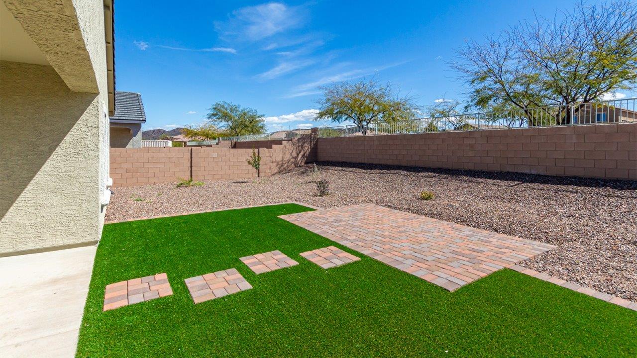 Step into The Kingston at Barnett Village, Marana, Arizona – a perfect blend of comfort, modern living, and energy efficiency. This thoughtfully crafted one-story home spans 2,068 square feet and offers four bedrooms and two bathrooms, ideal for families of all sizes.  The open-concept design features a spacious great room that effortlessly connects with the kitchen and dining area, creating an inviting central hub for everyday living and entertaining. The kitchen is equipped with contemporary appliances and a pantry, offering ample storage and convenience for meal preparation.  The primary bedroom, located at the rear of the home, provides a peaceful retreat with a private ensuite bathroom and a generous walk-in closet. The additional three bedrooms are positioned at the front of the house, offering versatility for use as guest rooms, a home office, or children’s bedrooms. Step outside to the covered patio, a perfect spot to enjoy the beautiful Arizona weather, whether for morning coffee or evening relaxation.  The Kingston also boasts a covered patio, perfect for enjoying Arizona’s beautiful desert evenings. Whether it’s morning coffee or evening relaxation, this outdoor space extends your living area into the serene landscape of Barnett Village.  Built with energy efficiency as a priority, the Kingston includes smart home technology, which not only simplifies daily living but also helps reduce utility costs. A two-car garage provides ample parking and additional storage space, enhancing the home’s functionality.  *Images shown are for reference only. They depict The Kingston sales model home and may not represent the actual home.