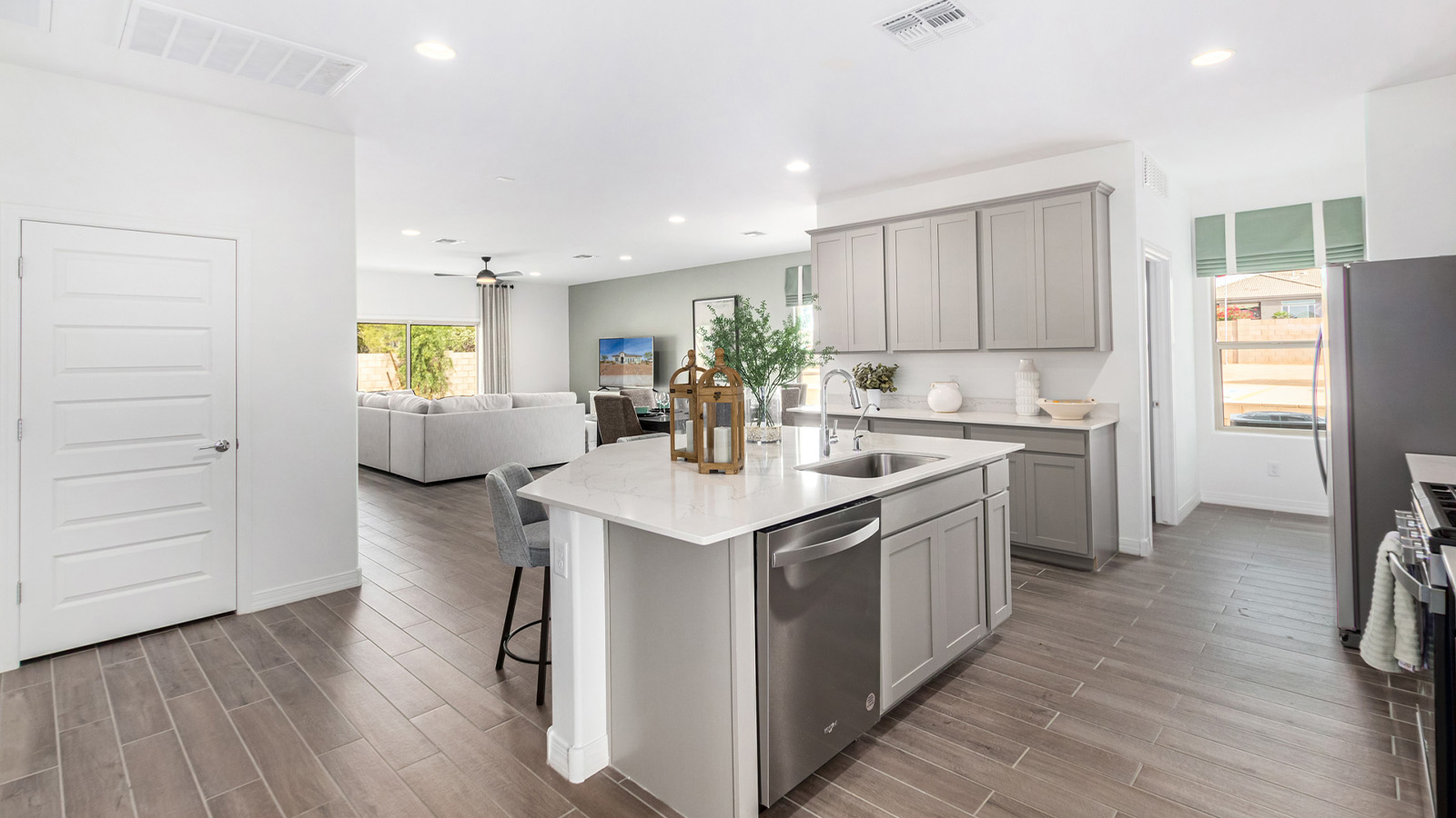 Step into The Kingston at Barnett Village, Marana, Arizona – a perfect blend of comfort, modern living, and energy efficiency. This thoughtfully crafted one-story home spans 2,068 square feet and offers four bedrooms and two bathrooms, ideal for families of all sizes.  The open-concept design features a spacious great room that effortlessly connects with the kitchen and dining area, creating an inviting central hub for everyday living and entertaining. The kitchen is equipped with contemporary appliances and a pantry, offering ample storage and convenience for meal preparation.  The primary bedroom, located at the rear of the home, provides a peaceful retreat with a private ensuite bathroom and a generous walk-in closet. The additional three bedrooms are positioned at the front of the house, offering versatility for use as guest rooms, a home office, or children’s bedrooms. Step outside to the covered patio, a perfect spot to enjoy the beautiful Arizona weather, whether for morning coffee or evening relaxation.  The Kingston also boasts a covered patio, perfect for enjoying Arizona’s beautiful desert evenings. Whether it’s morning coffee or evening relaxation, this outdoor space extends your living area into the serene landscape of Barnett Village.  Built with energy efficiency as a priority, the Kingston includes smart home technology, which not only simplifies daily living but also helps reduce utility costs. A two-car garage provides ample parking and additional storage space, enhancing the home’s functionality.