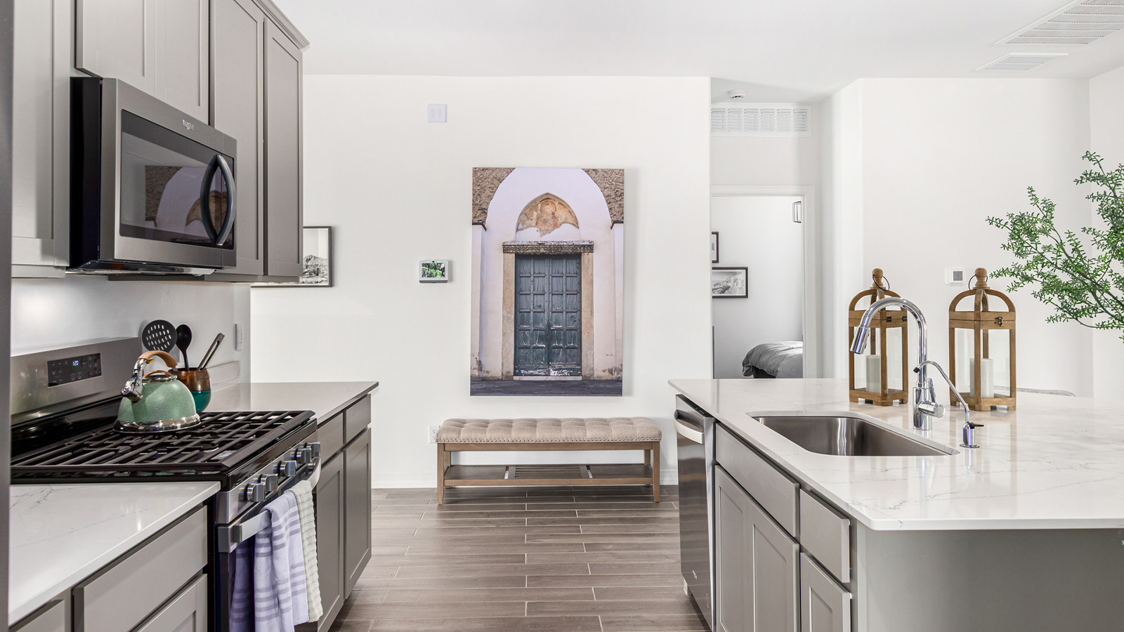 Step into The Kingston at Barnett Village, Marana, Arizona – a perfect blend of comfort, modern living, and energy efficiency. This thoughtfully crafted one-story home spans 2,068 square feet and offers four bedrooms and two bathrooms, ideal for families of all sizes.  The open-concept design features a spacious great room that effortlessly connects with the kitchen and dining area, creating an inviting central hub for everyday living and entertaining. The kitchen is equipped with contemporary appliances and a pantry, offering ample storage and convenience for meal preparation.  The primary bedroom, located at the rear of the home, provides a peaceful retreat with a private ensuite bathroom and a generous walk-in closet. The additional three bedrooms are positioned at the front of the house, offering versatility for use as guest rooms, a home office, or children’s bedrooms. Step outside to the covered patio, a perfect spot to enjoy the beautiful Arizona weather, whether for morning coffee or evening relaxation.  The Kingston also boasts a covered patio, perfect for enjoying Arizona’s beautiful desert evenings. Whether it’s morning coffee or evening relaxation, this outdoor space extends your living area into the serene landscape of Barnett Village.  Built with energy efficiency as a priority, the Kingston includes smart home technology, which not only simplifies daily living but also helps reduce utility costs. A two-car garage provides ample parking and additional storage space, enhancing the home’s functionality.