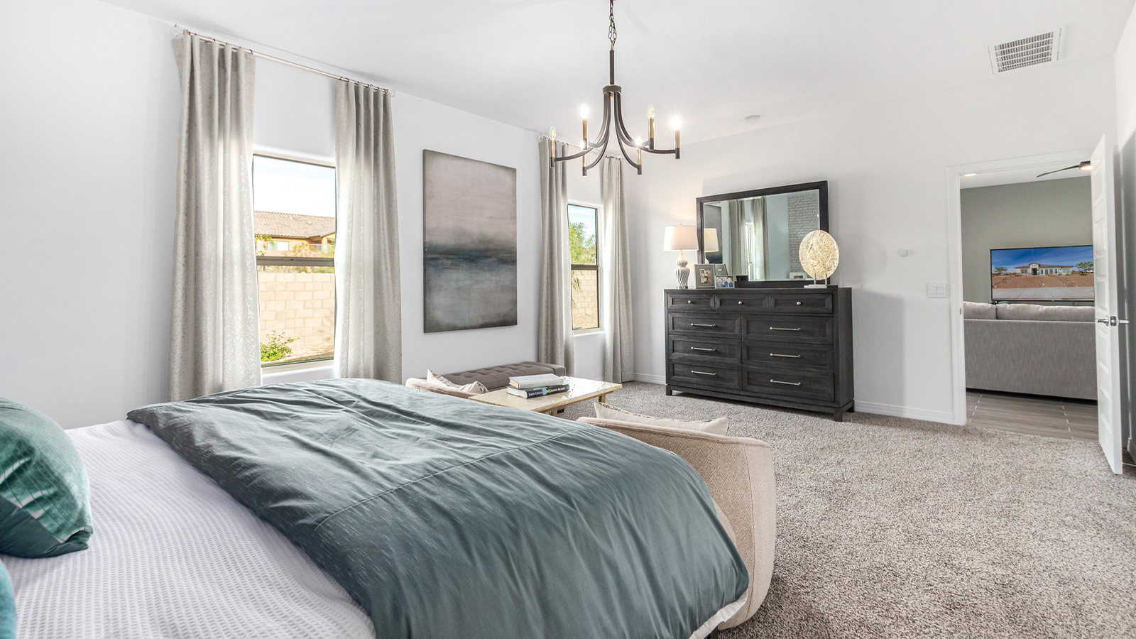 Step into The Kingston at Barnett Village, Marana, Arizona – a perfect blend of comfort, modern living, and energy efficiency. This thoughtfully crafted one-story home spans 2,068 square feet and offers four bedrooms and two bathrooms, ideal for families of all sizes.  The open-concept design features a spacious great room that effortlessly connects with the kitchen and dining area, creating an inviting central hub for everyday living and entertaining. The kitchen is equipped with contemporary appliances and a pantry, offering ample storage and convenience for meal preparation.  The primary bedroom, located at the rear of the home, provides a peaceful retreat with a private ensuite bathroom and a generous walk-in closet. The additional three bedrooms are positioned at the front of the house, offering versatility for use as guest rooms, a home office, or children’s bedrooms. Step outside to the covered patio, a perfect spot to enjoy the beautiful Arizona weather, whether for morning coffee or evening relaxation.  The Kingston also boasts a covered patio, perfect for enjoying Arizona’s beautiful desert evenings. Whether it’s morning coffee or evening relaxation, this outdoor space extends your living area into the serene landscape of Barnett Village.  Built with energy efficiency as a priority, the Kingston includes smart home technology, which not only simplifies daily living but also helps reduce utility costs. A two-car garage provides ample parking and additional storage space, enhancing the home’s functionality.