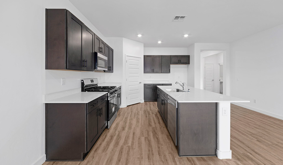 Introducing the York — a thoughtfully designed new floor plan at Solterra by D.R. Horton in Green Valley. Offering 1,863 square feet of well-planned living space, the York is ideal for those seeking a home that balances comfort, flexibility, and modern design.  Step inside through the welcoming entryway and experience an open-concept layout that maximizes every square foot. The expansive great room serves as the heart of the home, flowing seamlessly into the dining area and kitchen, perfect for both everyday living and entertaining. The kitchen features a spacious center island, quartz countertops, Shaker-style cabinetry, and a dedicated pantry, delivering a clean, modern aesthetic with ample storage for all your culinary essentials.  The York is available in two- and three-bedroom configurations, offering flexibility to meet a variety of lifestyle needs. The primary suite is thoughtfully located at the rear of the home for added privacy and includes a linen closet, walk-in closet, and a well-appointed ensuite bathroom. Near the front of the home is a powder room, guest bedroom with walk-in closet and ensuite bathroom, and study that creates a functional layout for guests, work-from-home needs, or additional living space.  Designed with both comfort and practicality in mind, the York includes a utility room conveniently located near the kitchen and garage, providing easy access to the laundry area and additional storage. A covered back patio extends the living space outdoors—ideal for relaxing and enjoying Green Valley’s beautiful year-round weather.  Homes at Solterra feature elegant, modern interiors paired with distinctive exterior details, including sand finish texture stucco, landscaped front yards with auto drip irrigation, and fully fenced backyards. Covered back patios offer inviting spaces to unwind and take in Green Valley’s breathtaking sunsets. Inside, D.R. Horton’s Home is Connected® Smart Home package enhances everyday living with a smart thermostat, video doorbell, keyless entry, and a Wi-Fi–enabled garage door opener.  Outdoor enthusiasts will appreciate the close proximity to scenic neighborhood parks, Colossal Cave Mountain Park, and an extensive network of walking and biking trails throughout Green Valley—making the York a perfect blend of comfort, style, and lifestyle-driven design.