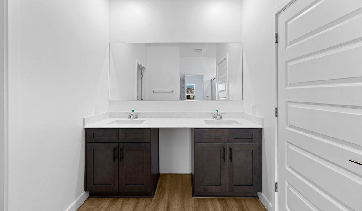 Introducing the York — a thoughtfully designed new floor plan at Solterra by D.R. Horton in Green Valley. Offering 1,863 square feet of well-planned living space, the York is ideal for those seeking a home that balances comfort, flexibility, and modern design.  Step inside through the welcoming entryway and experience an open-concept layout that maximizes every square foot. The expansive great room serves as the heart of the home, flowing seamlessly into the dining area and kitchen, perfect for both everyday living and entertaining. The kitchen features a spacious center island, quartz countertops, Shaker-style cabinetry, and a dedicated pantry, delivering a clean, modern aesthetic with ample storage for all your culinary essentials.  The York is available in two- and three-bedroom configurations, offering flexibility to meet a variety of lifestyle needs. The primary suite is thoughtfully located at the rear of the home for added privacy and includes a linen closet, walk-in closet, and a well-appointed ensuite bathroom. Near the front of the home is a powder room, guest bedroom with walk-in closet and ensuite bathroom, and study that creates a functional layout for guests, work-from-home needs, or additional living space.  Designed with both comfort and practicality in mind, the York includes a utility room conveniently located near the kitchen and garage, providing easy access to the laundry area and additional storage. A covered back patio extends the living space outdoors—ideal for relaxing and enjoying Green Valley’s beautiful year-round weather.  Homes at Solterra feature elegant, modern interiors paired with distinctive exterior details, including sand finish texture stucco, landscaped front yards with auto drip irrigation, and fully fenced backyards. Covered back patios offer inviting spaces to unwind and take in Green Valley’s breathtaking sunsets. Inside, D.R. Horton’s Home is Connected® Smart Home package enhances everyday living with a smart thermostat, video doorbell, keyless entry, and a Wi-Fi–enabled garage door opener.  Outdoor enthusiasts will appreciate the close proximity to scenic neighborhood parks, Colossal Cave Mountain Park, and an extensive network of walking and biking trails throughout Green Valley—making the York a perfect blend of comfort, style, and lifestyle-driven design.