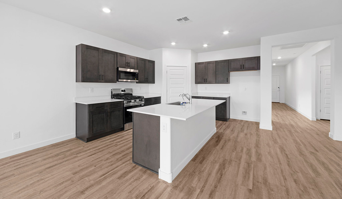 Introducing the York — a thoughtfully designed new floor plan at Solterra by D.R. Horton in Green Valley. Offering 1,863 square feet of well-planned living space, the York is ideal for those seeking a home that balances comfort, flexibility, and modern design.  Step inside through the welcoming entryway and experience an open-concept layout that maximizes every square foot. The expansive great room serves as the heart of the home, flowing seamlessly into the dining area and kitchen, perfect for both everyday living and entertaining. The kitchen features a spacious center island, quartz countertops, Shaker-style cabinetry, and a dedicated pantry, delivering a clean, modern aesthetic with ample storage for all your culinary essentials.  The York is available in two- and three-bedroom configurations, offering flexibility to meet a variety of lifestyle needs. The primary suite is thoughtfully located at the rear of the home for added privacy and includes a linen closet, walk-in closet, and a well-appointed ensuite bathroom. Near the front of the home is a powder room, guest bedroom with walk-in closet and ensuite bathroom, and study that creates a functional layout for guests, work-from-home needs, or additional living space.  Designed with both comfort and practicality in mind, the York includes a utility room conveniently located near the kitchen and garage, providing easy access to the laundry area and additional storage. A covered back patio extends the living space outdoors—ideal for relaxing and enjoying Green Valley’s beautiful year-round weather.  Homes at Solterra feature elegant, modern interiors paired with distinctive exterior details, including sand finish texture stucco, landscaped front yards with auto drip irrigation, and fully fenced backyards. Covered back patios offer inviting spaces to unwind and take in Green Valley’s breathtaking sunsets. Inside, D.R. Horton’s Home is Connected® Smart Home package enhances everyday living with a smart thermostat, video doorbell, keyless entry, and a Wi-Fi–enabled garage door opener.  Outdoor enthusiasts will appreciate the close proximity to scenic neighborhood parks, Colossal Cave Mountain Park, and an extensive network of walking and biking trails throughout Green Valley—making the York a perfect blend of comfort, style, and lifestyle-driven design.