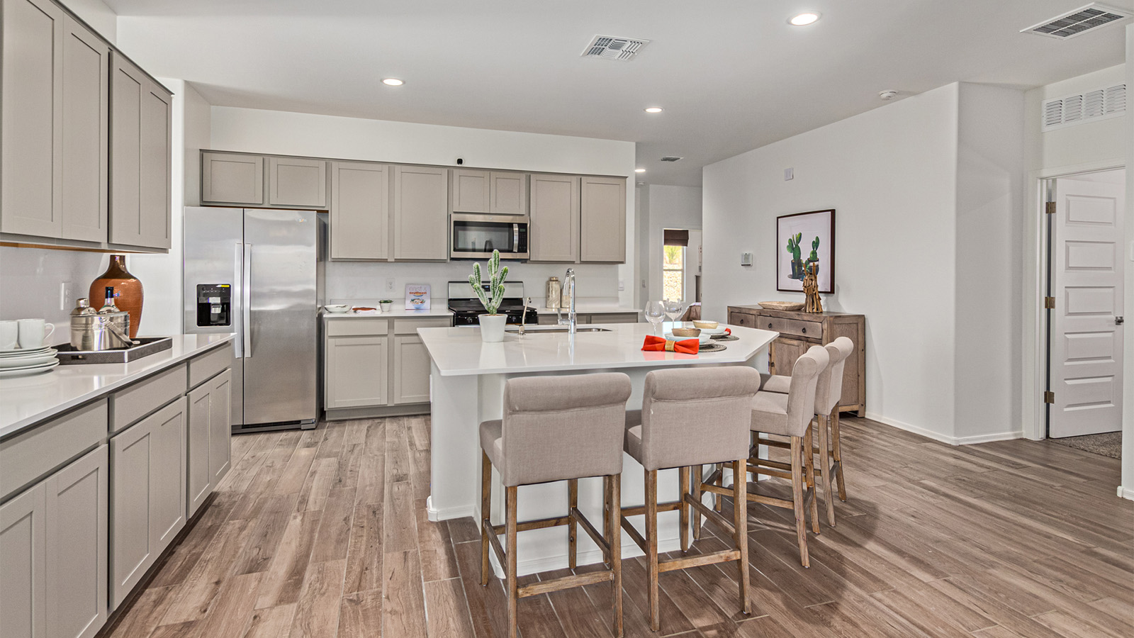 Introducing the Kingston at Entrada Del Toro  The Kingston is a spacious and thoughtfully designed single-story home located in the highly desirable Entrada Del Toro neighborhood within the master-planned community of Rancho Sahuarita. Offering 2,172 square feet of well-appointed living space, this inviting floor plan features four bedrooms, two full bathrooms, a grand kitchen island, a covered back patio, and a two-car garage—ideal for households seeking space, flexibility, and room to thrive.  From the moment you step inside, a welcoming entryway opens into an expansive open-concept layout that seamlessly connects the great room, dining area, and kitchen, creating a bright and airy space perfect for everyday living and effortless entertaining. The kitchen serves as the heart of the home, showcasing a large center island, Shaker-style cabinetry, quartz countertops, a walk-in pantry, and abundant storage for both function and style.  The Kingston features a well-planned split-bedroom design, with three secondary bedrooms located near the front of the home—ideal for family members, guests, home offices, or creative spaces. Privately situated at the rear of the home, the spacious primary suite offers a peaceful retreat complete with an en-suite bathroom and a generous walk-in closet.  *Images shown are for reference only. They depict the Kingston model home and may not represent the actual home.  Homes at Entrada Del Toro are designed with the future in mind. Exterior features include a light lace stucco finish, professionally landscaped front yards with automatic drip irrigation, and large, fully fenced backyards ready for your personal touch. Inside, the Home is Connected® Smart Home package provides modern convenience with a smart thermostat, video doorbell, keyless entry, and a Wi-Fi®–enabled garage door opener.  With its expansive living areas, flexible bedroom arrangement, and thoughtful design throughout, the Kingston delivers the perfect balance of comfort, convenience, and livability.  Residents of Entrada Del Toro enjoy access to Rancho Sahuarita’s extensive amenities, including a full-service fitness center, multiple resort-style swimming pools, pickleball courts, splash pads, playgrounds, and expansive parks designed for all ages and lifestyles. Homeowners will also enjoy exclusive access to the brand-new Entrada Del Toro Community Center, scheduled to open in Spring 2026, featuring modern gathering spaces and recreational amenities just moments from home.