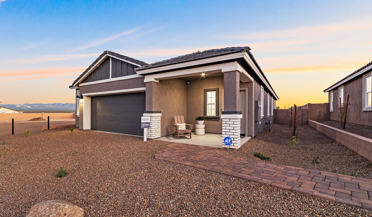 Introducing the Carolina — a thoughtfully designed single-story home offering 1,608 sq. ft. of modern comfort at Entrada Del Toro, a master-planned community in Rancho Sahuarita.  With three bedrooms, two full bathrooms, and a two-car garage, this efficient and beautifully planned layout is perfect for those seeking convenience, comfort, and single-level living.  A welcoming front porch invites you inside, where the entryway opens into a bright and beautifully crafted living space. The heart of the home is the well-appointed kitchen, featuring a large center island, walk-in pantry, and stylish Shaker-style cabinetry. Overlooking the dining area and great room, this open layout makes it easy to cook, gather, and entertain with ease.  The primary bedroom is thoughtfully positioned at the rear of the home, creating a private retreat. Complete with a large en-suite bathroom and walk-in closet, it’s designed for relaxation and convenience.  Two additional bedrooms are located toward the front of the home, offering flexibility for family, guests, a home office, or hobbies, and share a full secondary hallway bathroom.  Our homes at Entrada Del Toro are designed with the future in mind. Each home features a light lace stucco exterior, landscaped front yards with auto drip irrigation, and large backyards that are fully fenced and ready for your personal touch. Inside, the Home is Connected® Smart Home package brings modern convenience to your fingertips with a smart thermostat, video doorbell, keyless entry, and a Wi-Fi® enabled garage door opener.  With its smart layout, modern features, and effortless single-story living, the Carolina brings comfort and functionality together in a one beautifully designed home here at Entrada Del Toro.  Residents of Entrada Del Toro will enjoy access to Rancho Sahuarita’s extensive amenity offerings, which include a full-service fitness center, multiple large swimming pools, pickle-ball courts, splash pads, playgrounds, and sizable parks and recreational spaces designed for all ages and lifestyles. In addition, homeowners will have exclusive access to the brand-new Entrada Del Toro Community Center, scheduled to open Spring 2026, further enhancing the neighborhood experience with modern gathering and recreational spaces close to home.